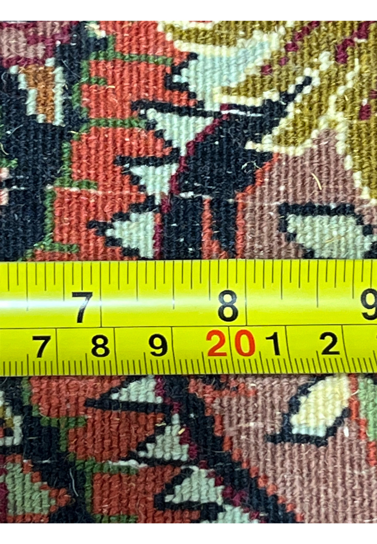 Close-up of the backside knots with measuring tape showing the dense weave of the Bijar Persian Iron Rug.