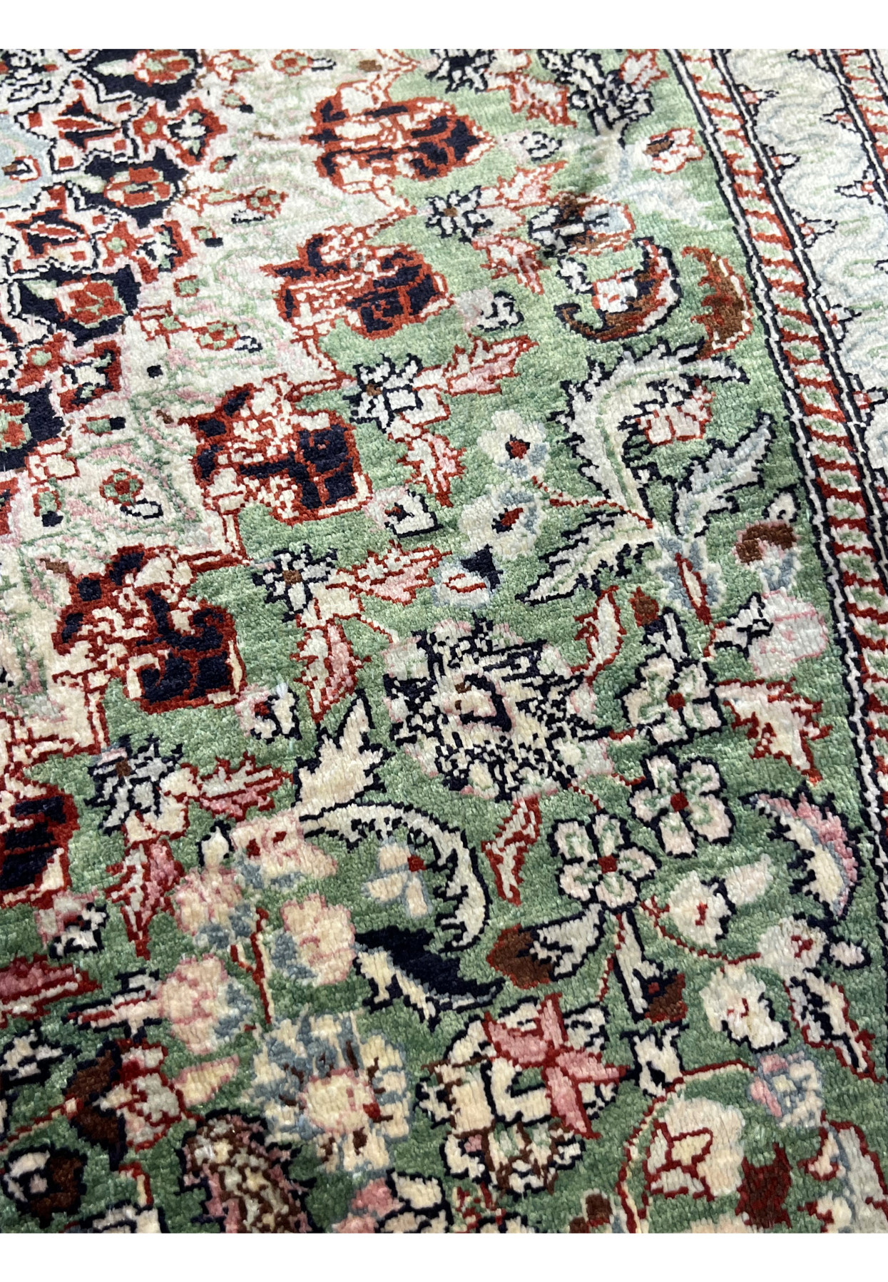 Pattern close-up of Persian Qum silk rug featuring tight floral motifs, crisp outlines, and micro-detailing from high knot density.