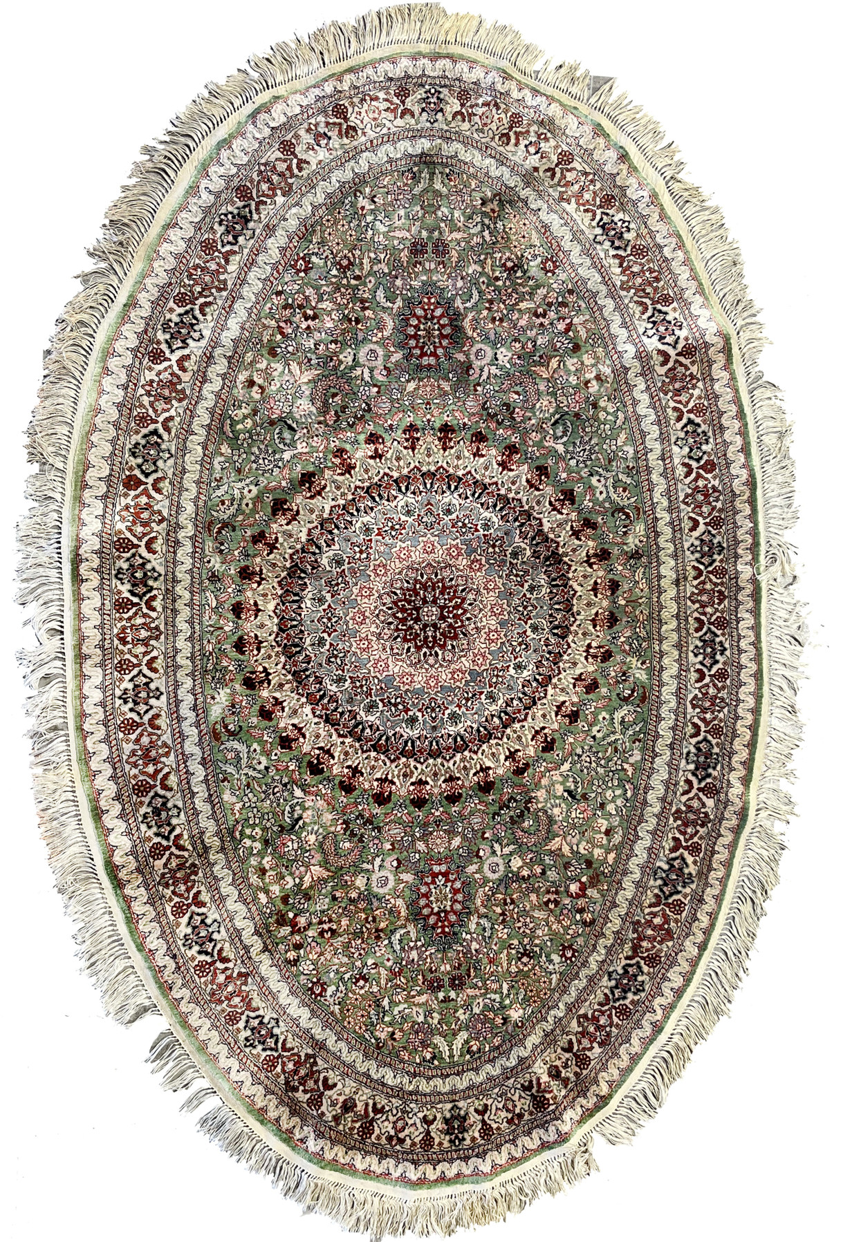Full oval view of Persian Qum pure silk rug with dense 600 KPSI floral design, central medallion, and rich green, red, and ivory detailing.