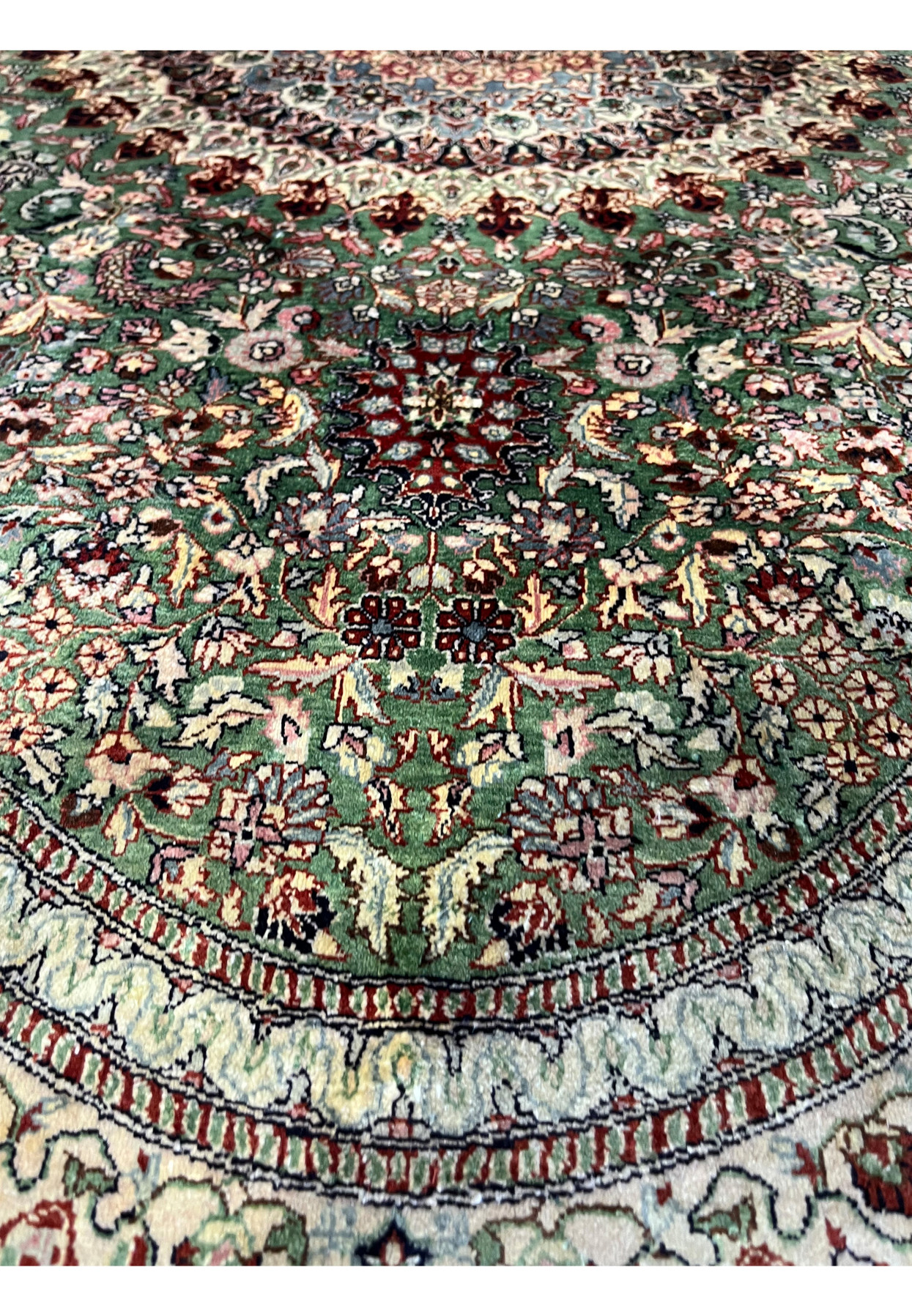 Lower border detail of the Persian Qum silk rug highlighting cream edging, floral repeats, and precise knot work.