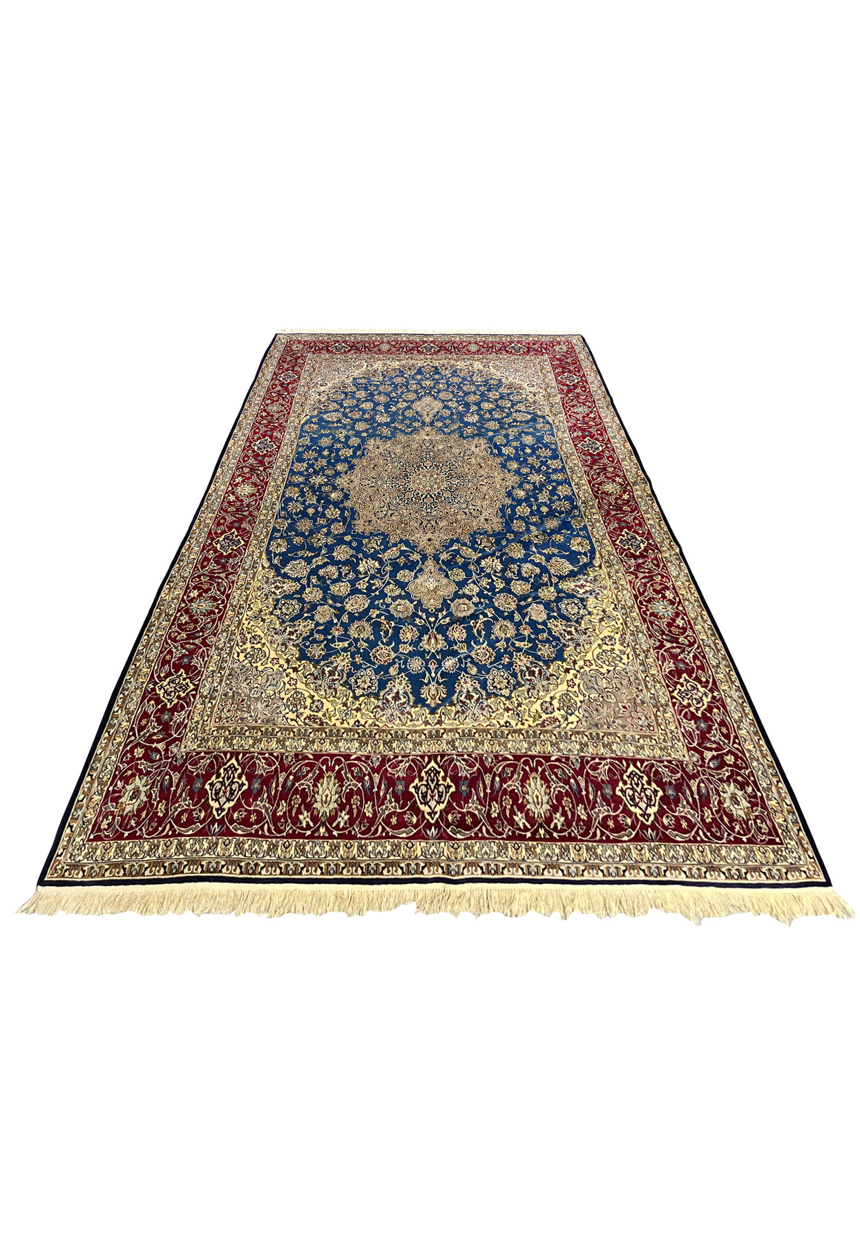 Full top view of a 6'9 x 11'2 Persian Isfahan rug with a blue field, ivory medallion, and rich red borders woven in wool and silk.