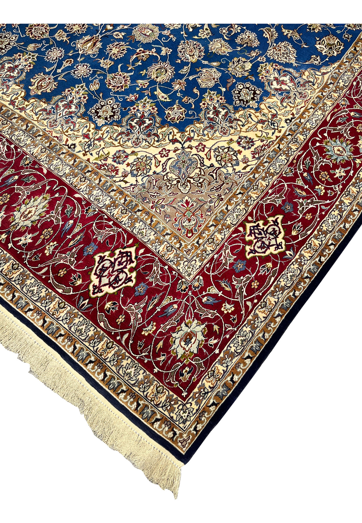 Edge and fringe view of the Persian Isfahan rug displaying precise knotting, red floral border, and navy outer edge.