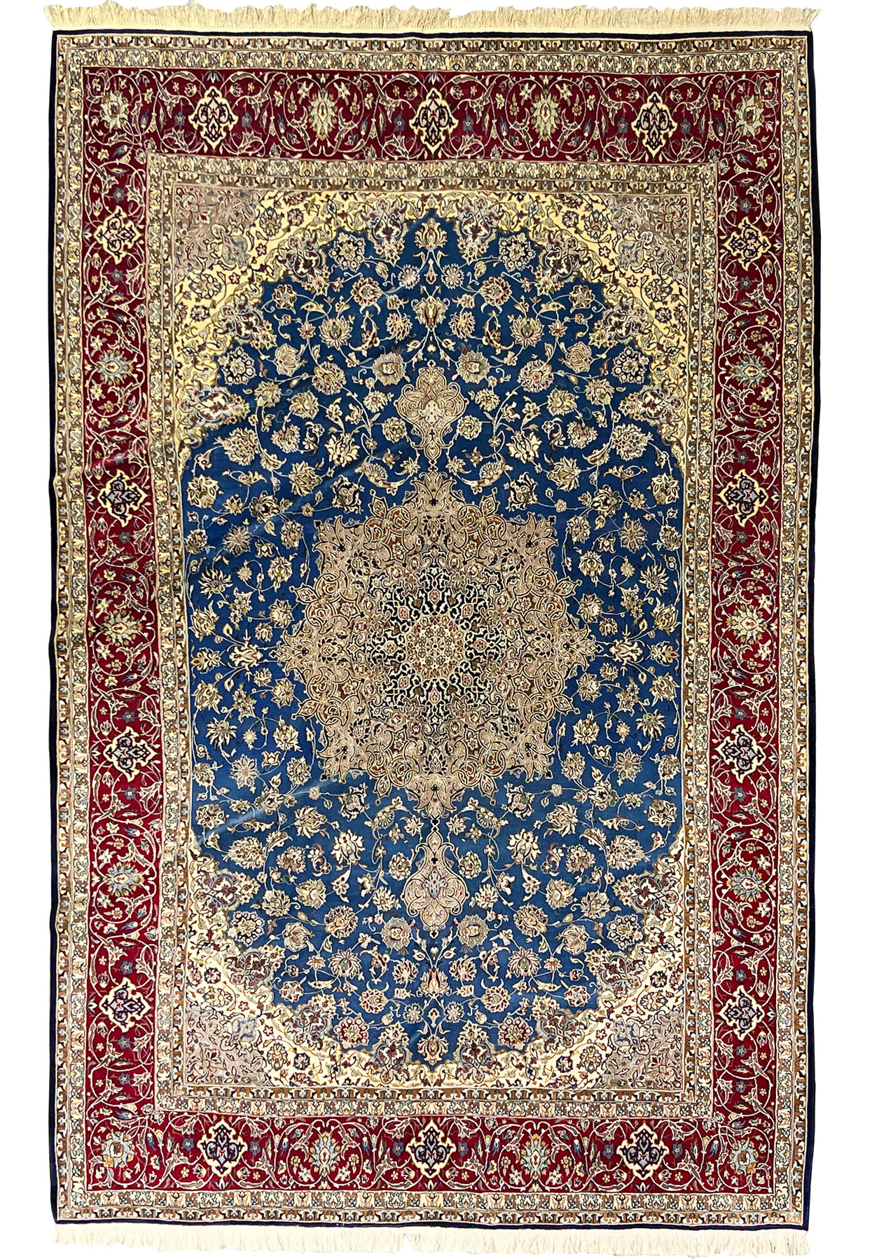 Complete overhead view showing the blue floral field, ornate central medallion, and deep red borders of this Persian Isfahan wool and silk rug.