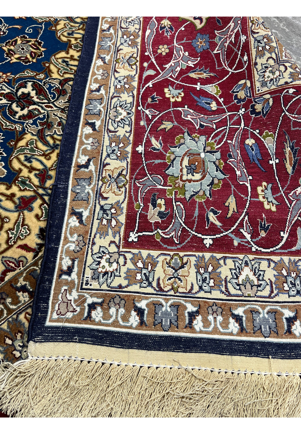 Back view of the Persian Isfahan rug showing tight knotting, clear floral outlines, and color transitions in the wool-and-silk weave.