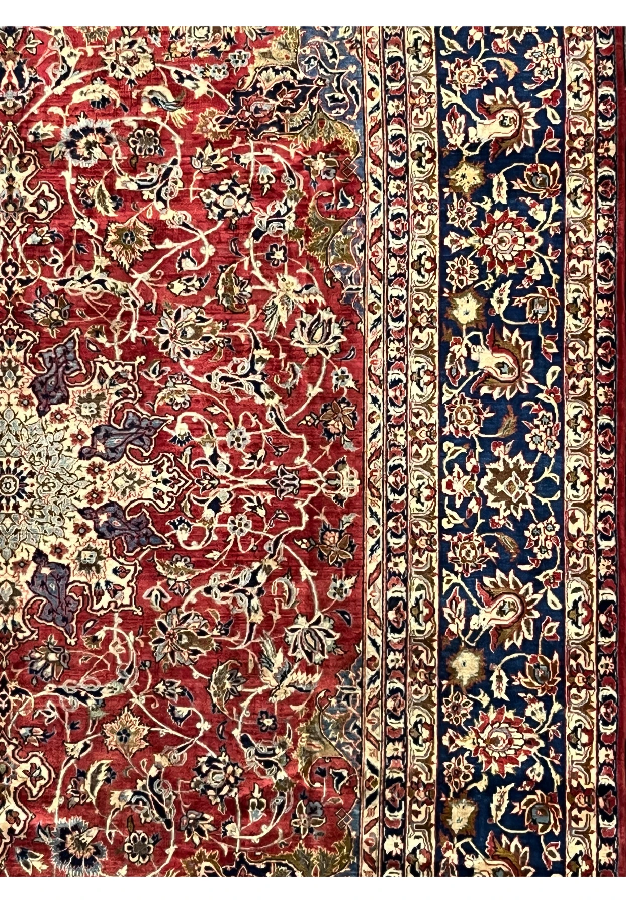 Border view of the vintage Najafabad rug showing deep navy floral motifs framed by intricate guard borders.