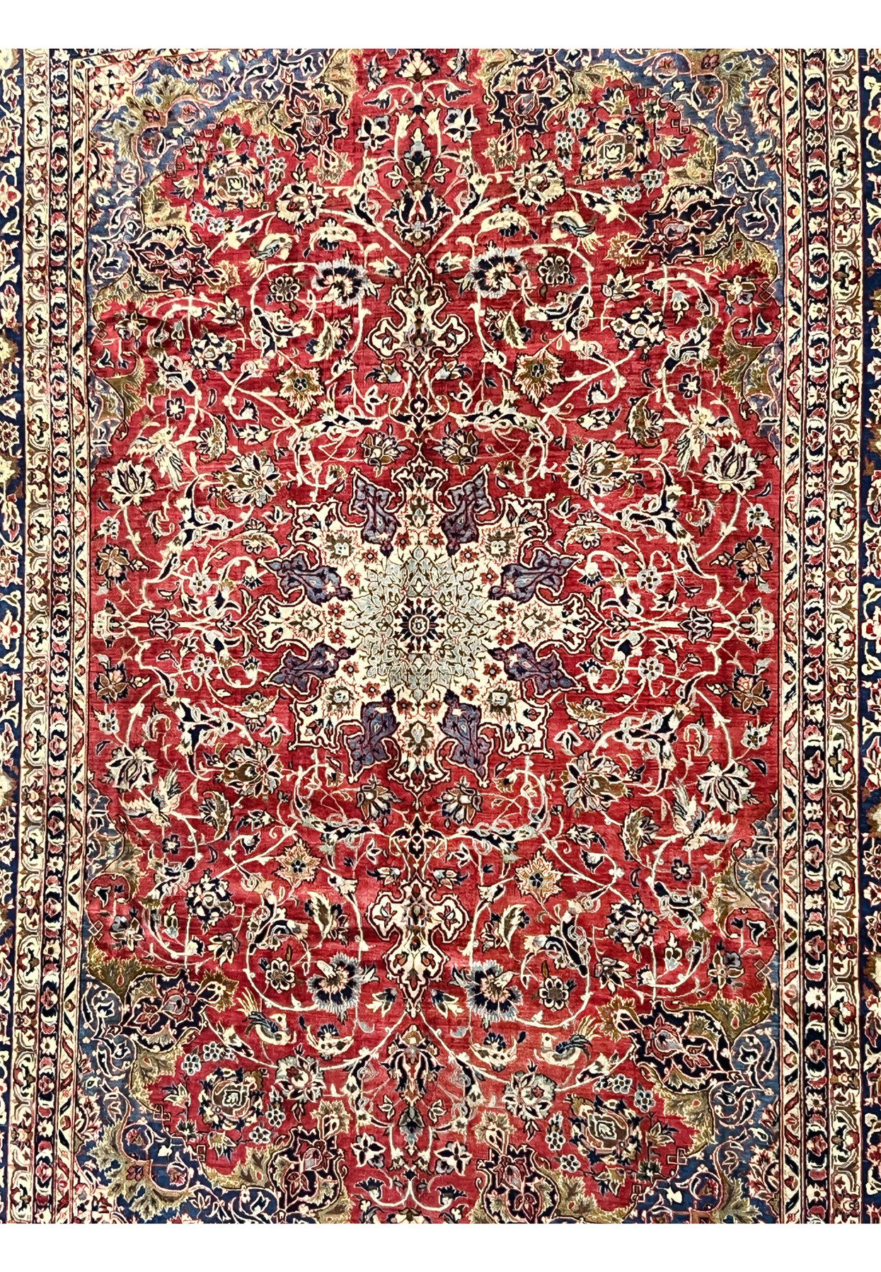 Close-up of the midfield showing the vintage Najafabad floral patterns with ruby red background and ivory vinework.