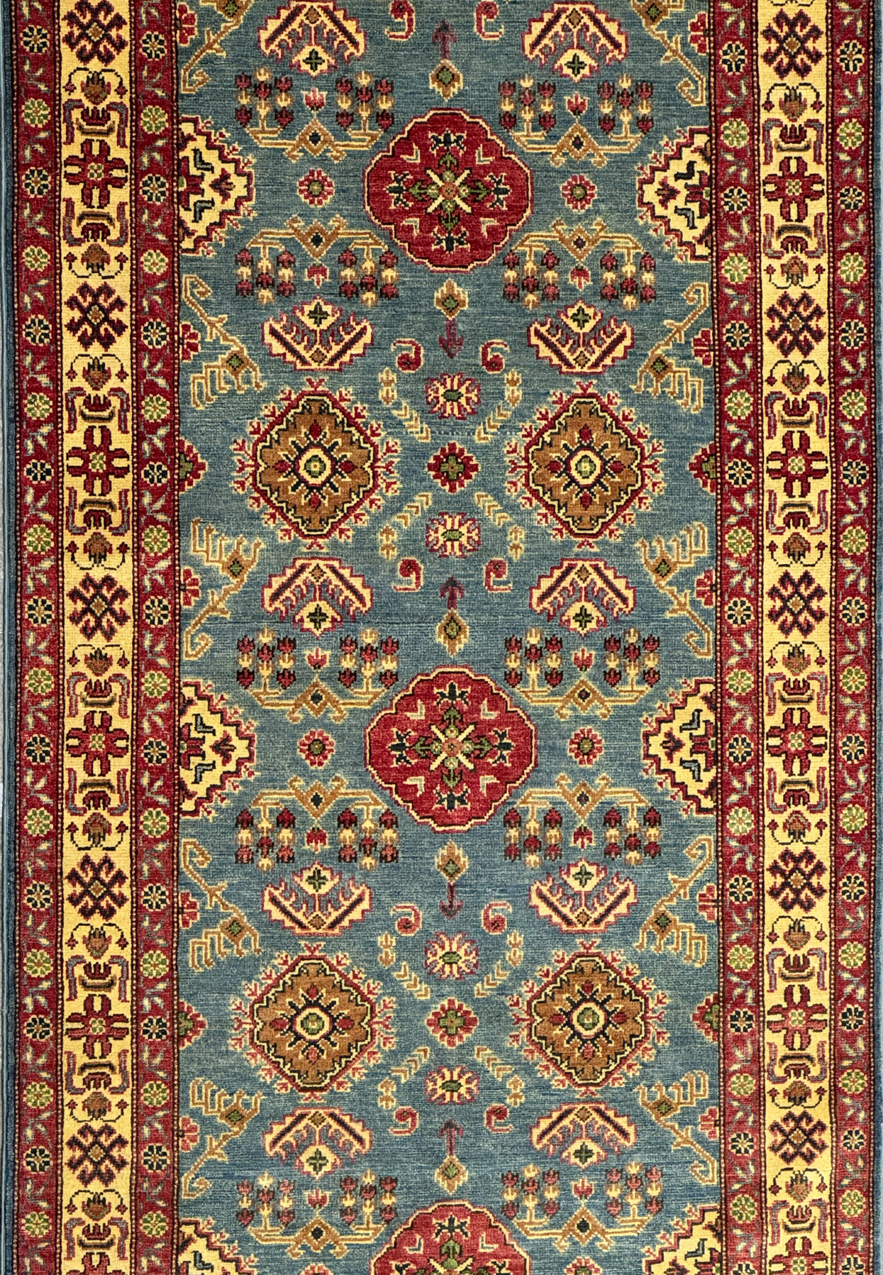 Close view of the midfield area with repeating medallions and tribal motifs.