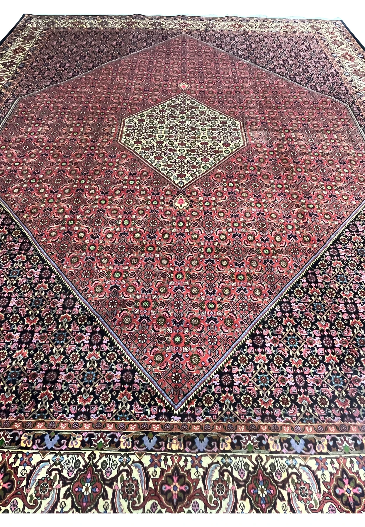 Top view of Persian Bijar iron rug highlighting compact knotting, high density wool construction, and intricate repeating floral lattice