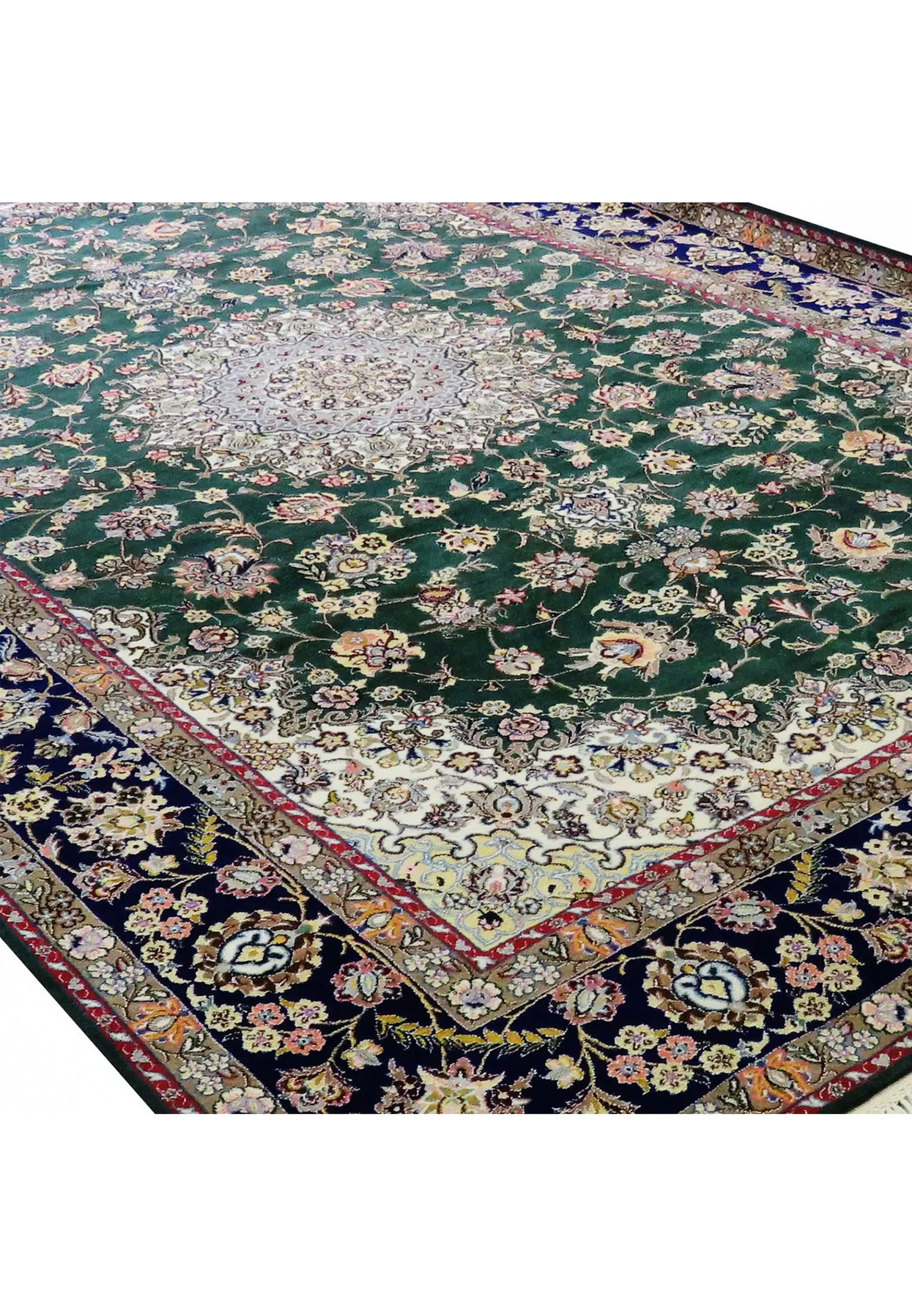 Corner detail of Persian Nain 9LA rug in forest green with navy blue border, ivory field accents, gold and blush floral motifs