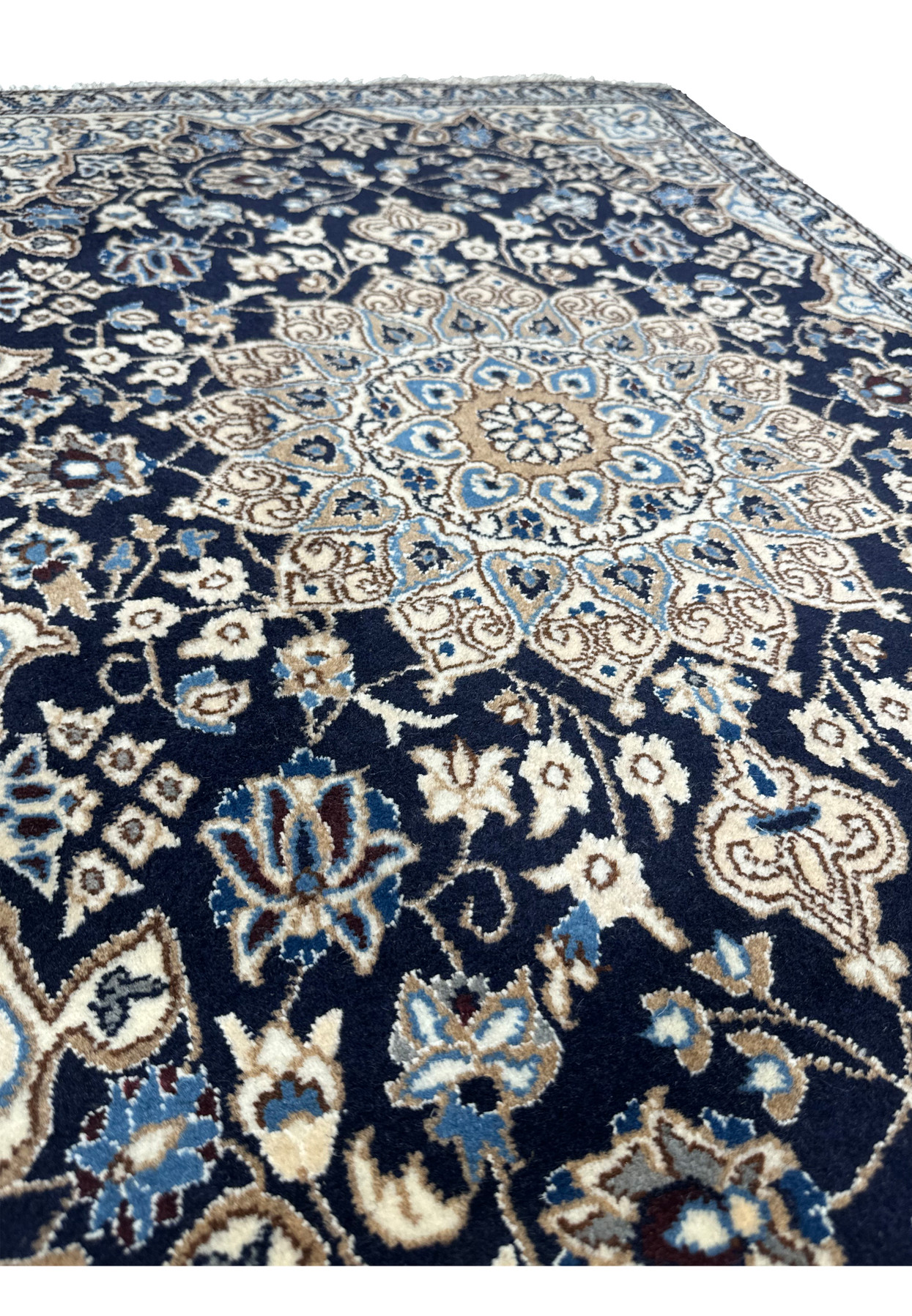 Angled perspective of 3x5 Persian Nain rug showing navy blue pile depth, ivory medallion contrast, and fine floral weaving