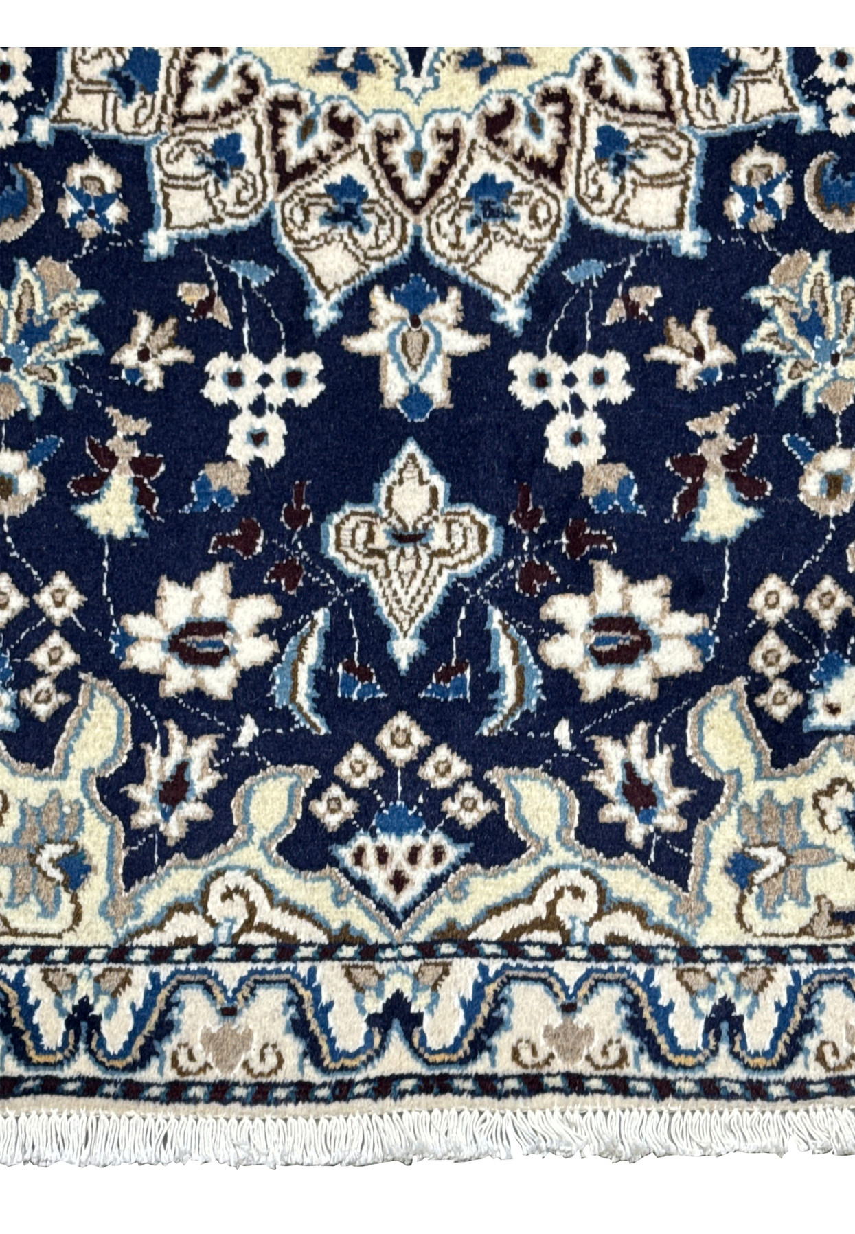 Lower field detail showing ivory floral motifs on deep royal navy Persian Nain rug
