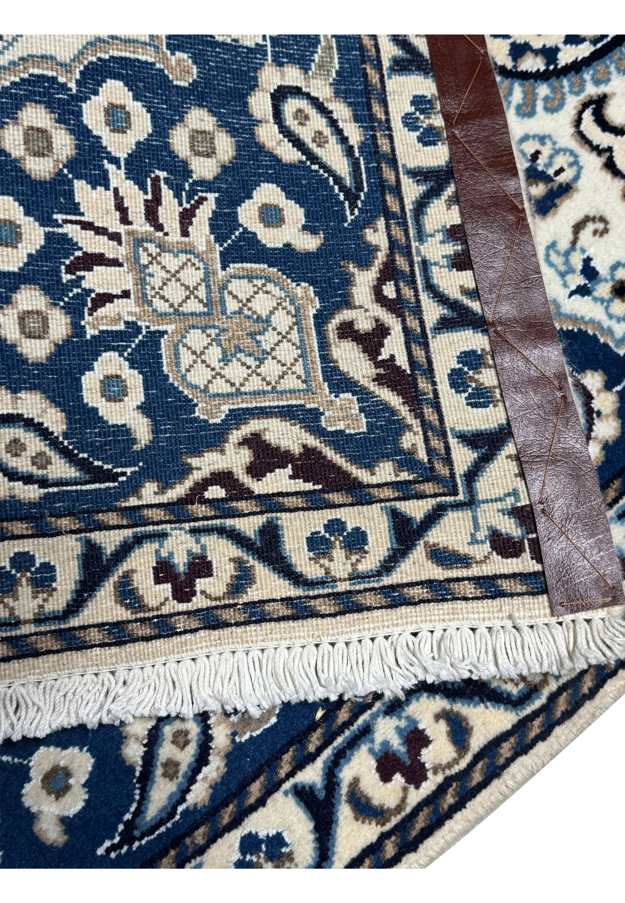 Backside of Persian Nain rug showing tight knot structure, cotton foundation, and precise weave with navy and ivory pattern visibility