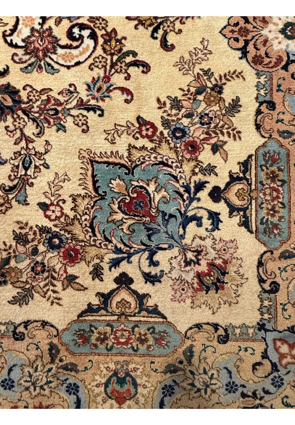 Detailed close up of floral vines with rust red, blush pink and moss green wool color accents