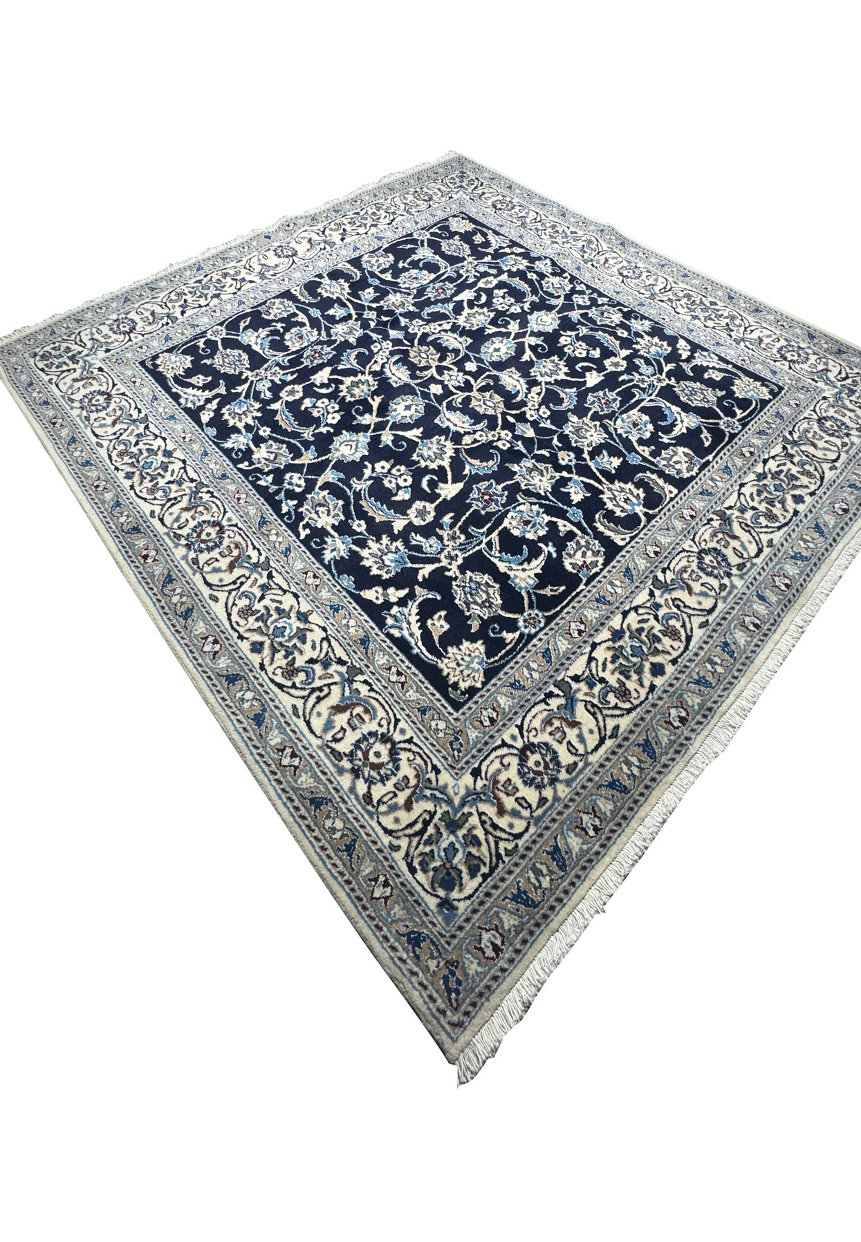 Angled perspective of square Persian Nain rug highlighting fine wool pile, crisp floral pattern, and elegant border detail