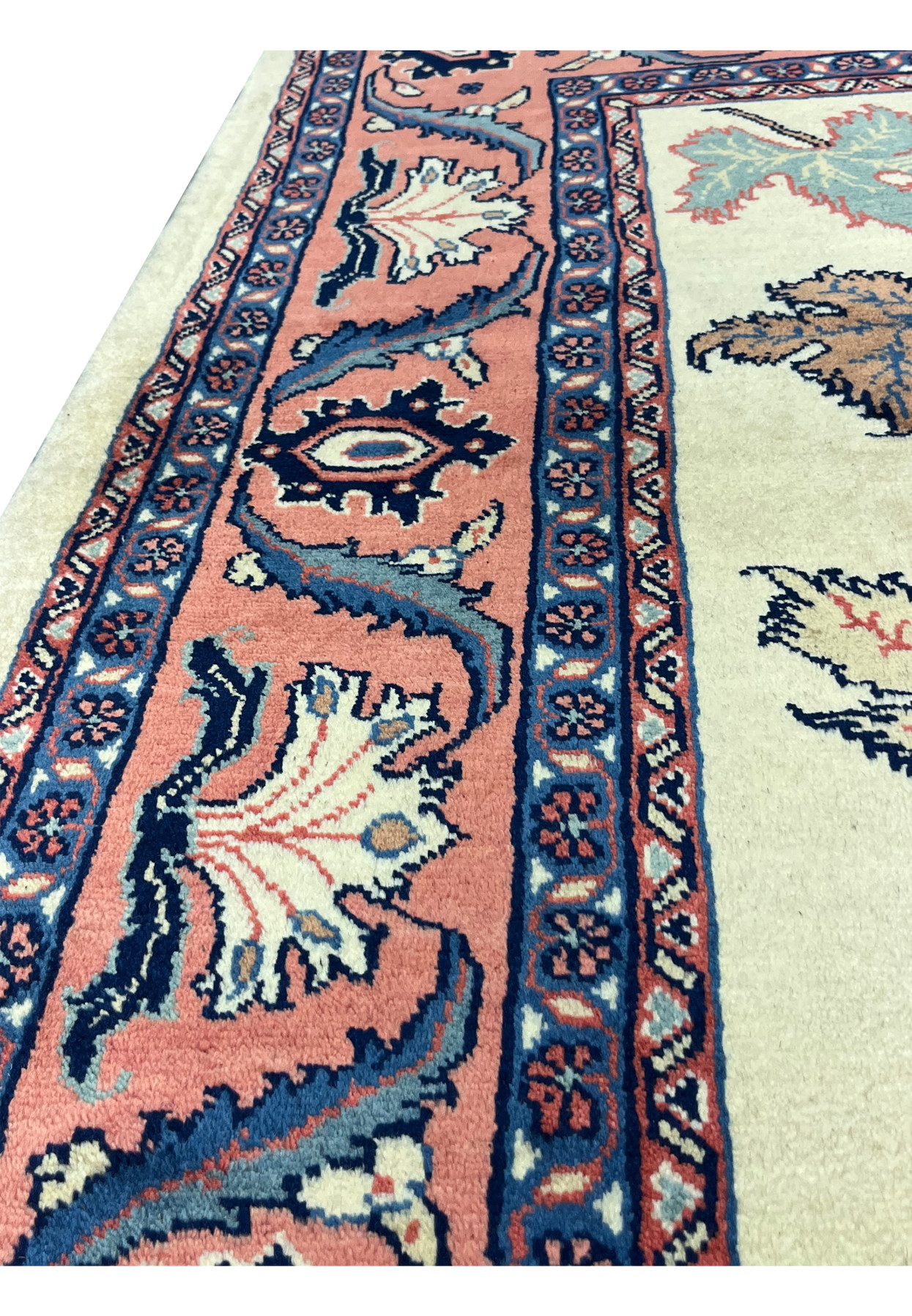 Close up of the outer border on a Persian Farahan rug showing floral details and traditional color palette