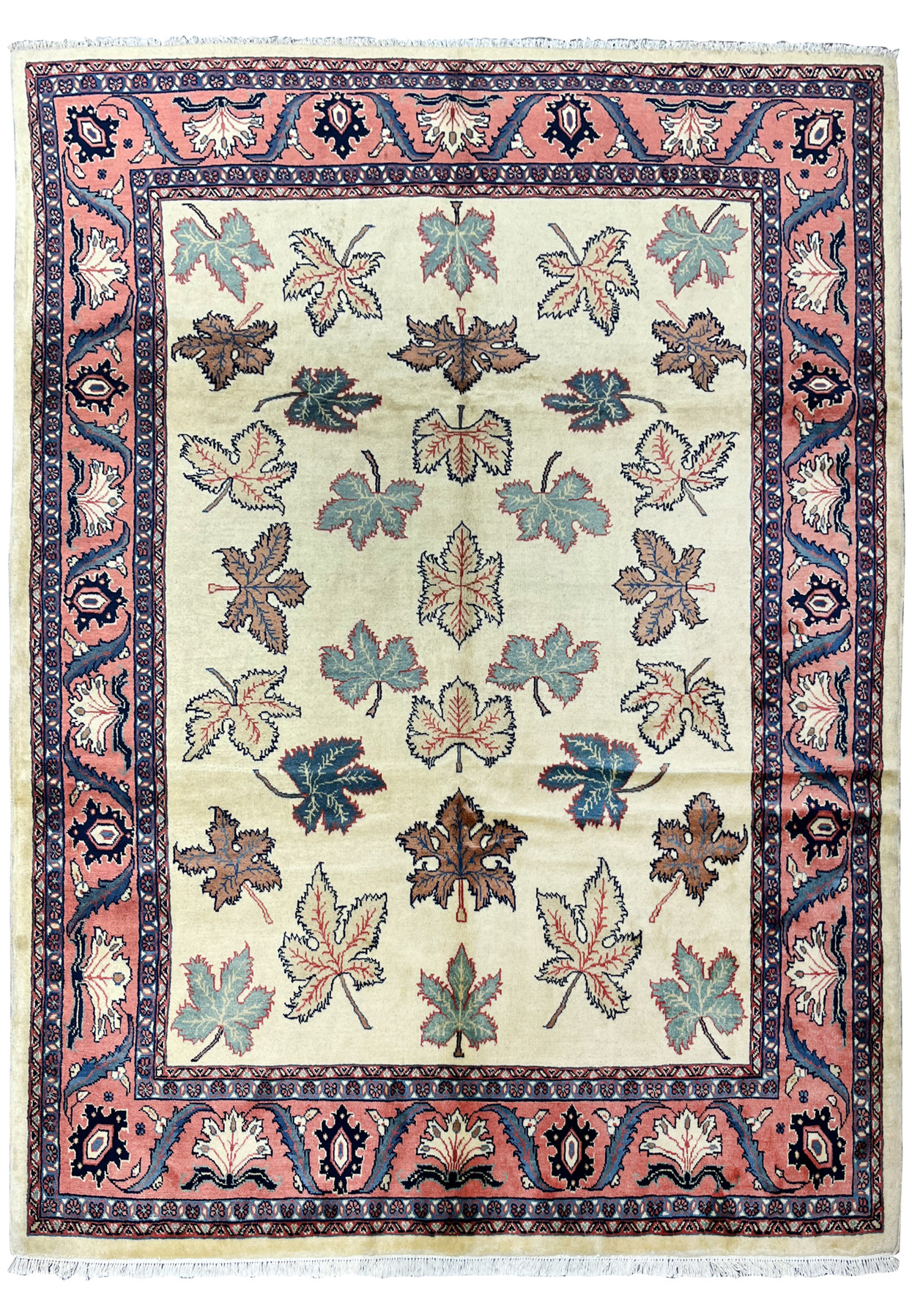 Full view of a hand knotted Persian Farahan rug with ivory field, allover leaf motifs, and salmon pink botanical border