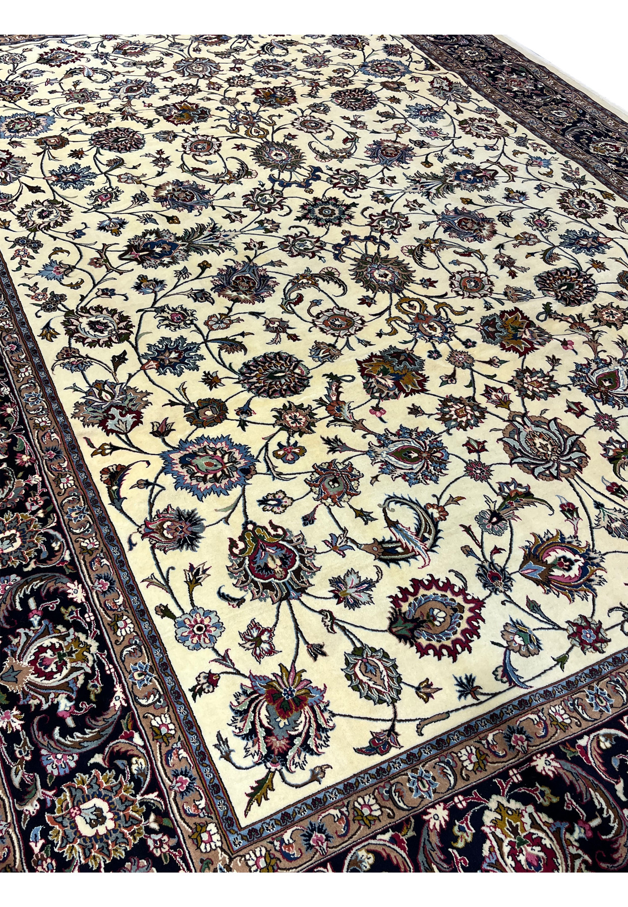 Close-up of ivory field floral motifs in signed Persian Mashad Saber rug