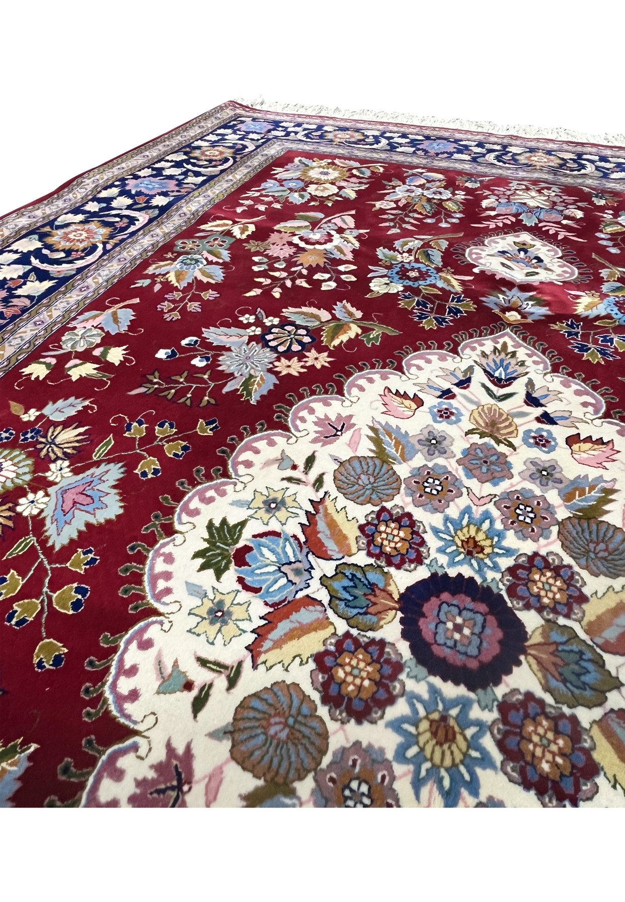 Upper edge detail of Persian Isfahan rug showing layered guard borders and precise hand finishing