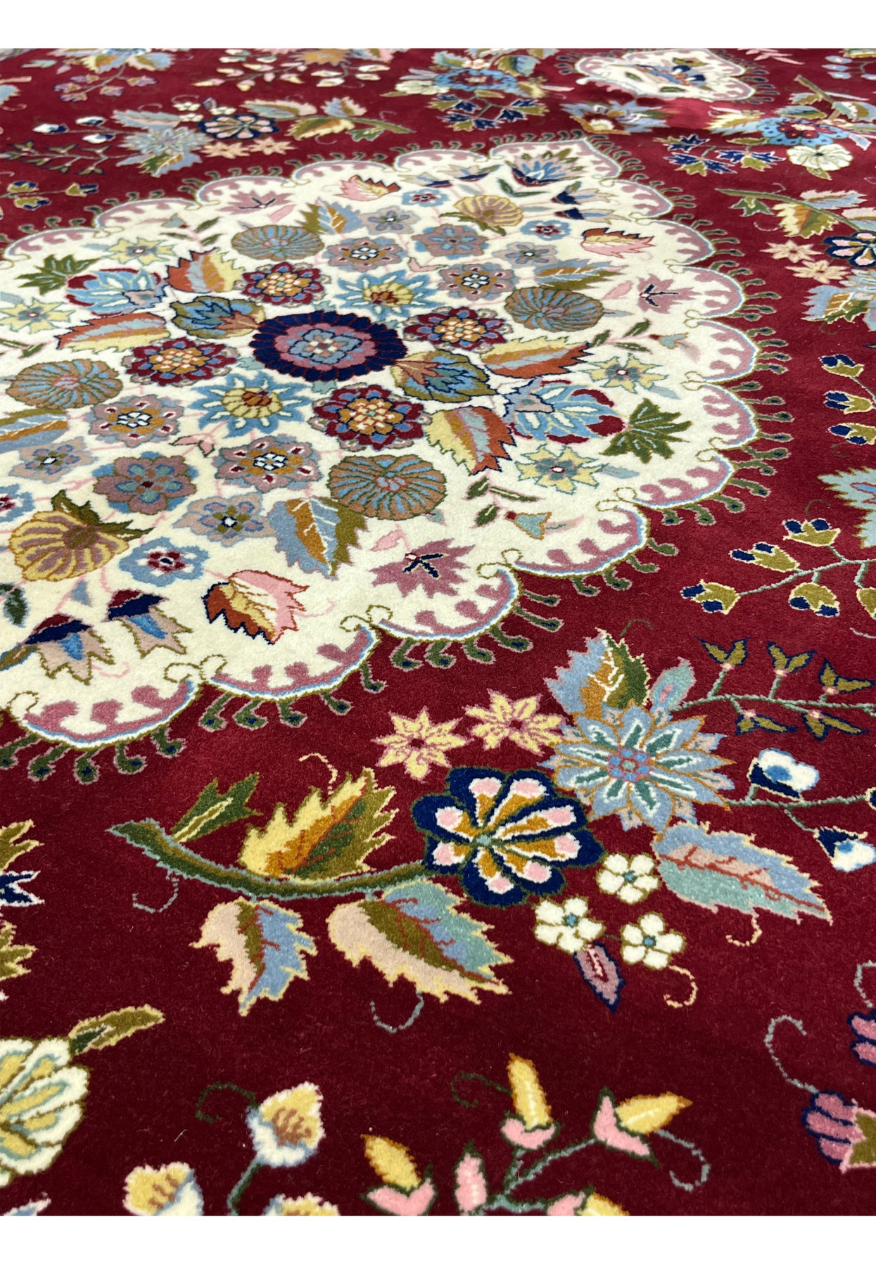 Detailed floral motifs on Persian Isfahan rug featuring silk highlights on burgundy wool field