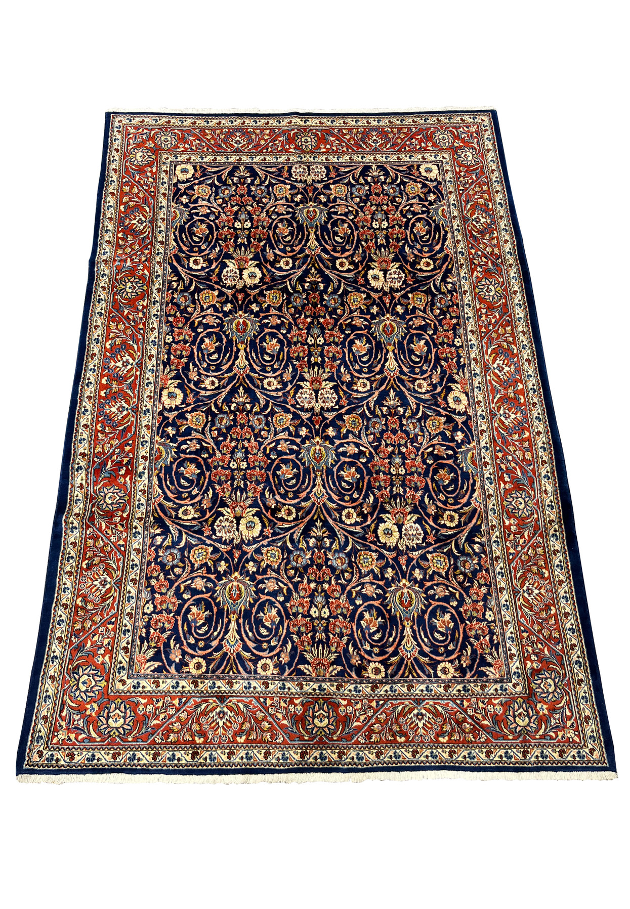 Top view of Persian Sarough rug showing navy blue field and balanced floral motifs