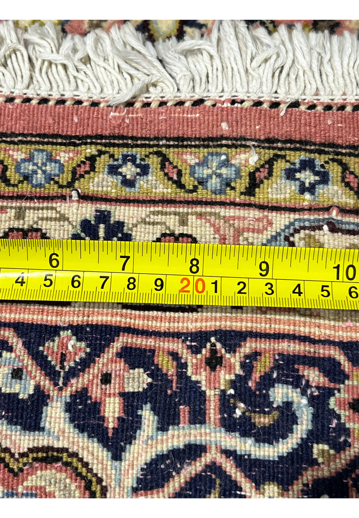 Backside of Persian Bijar rug with ruler demonstrating tight knot scale and heavy iron construction