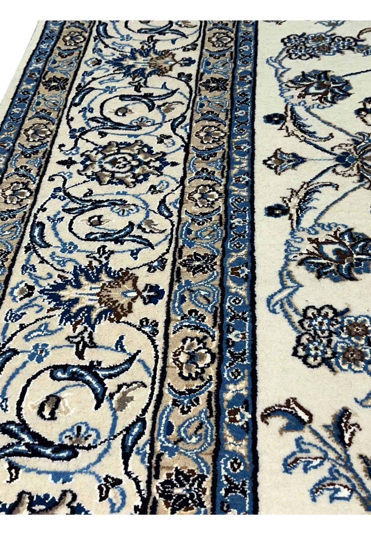 Detailed border view of Persian Nain 9 LA rug featuring layered blue motifs and precise hand-knotted outlines