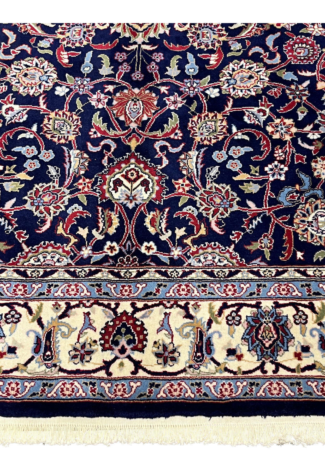 Lower border close-up of a Persian Sarough kork rug with ivory ground, floral rosettes, scrolling vines, and navy framing line