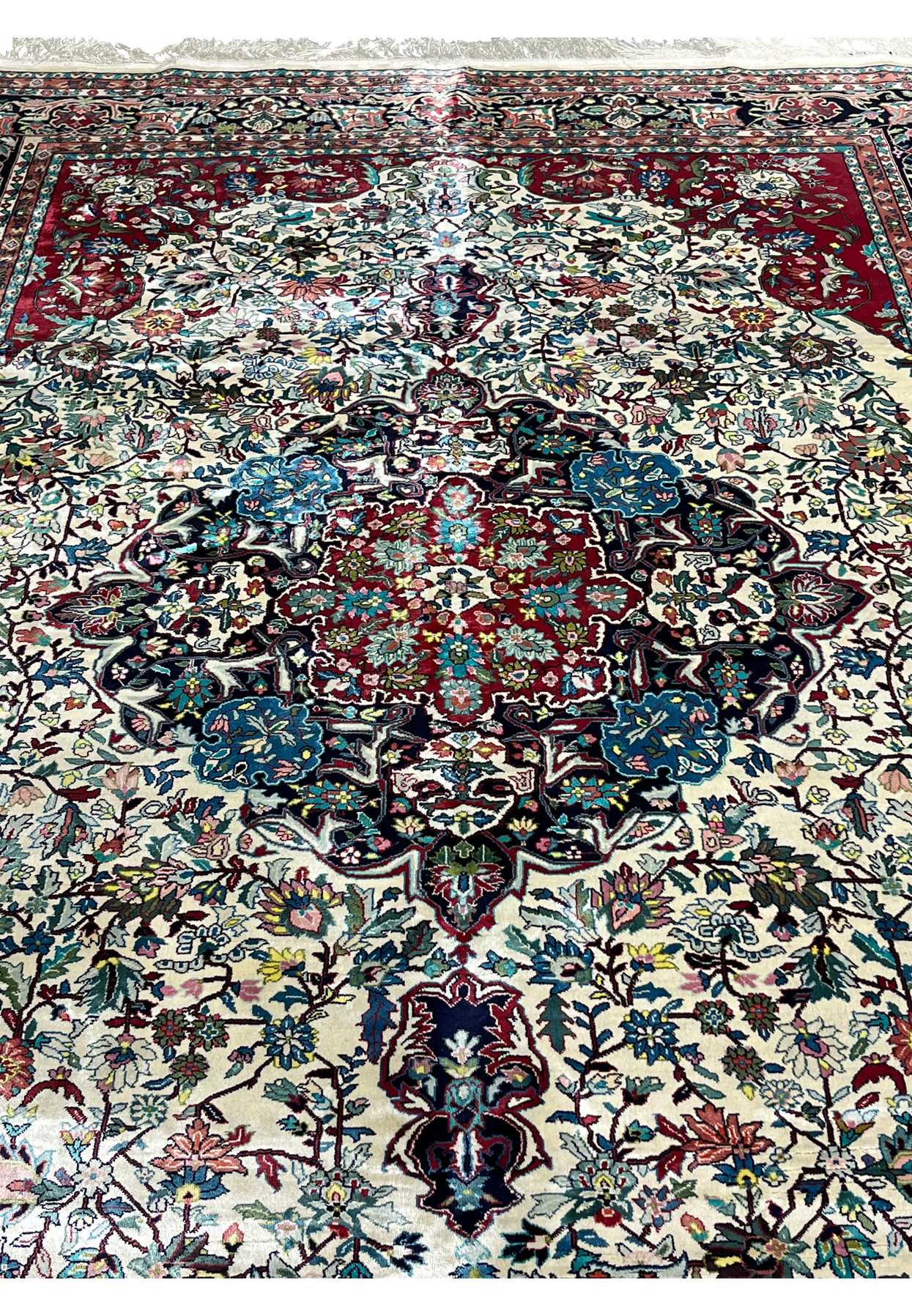 Close-up of floral medallion on fine weave oriental silk rug