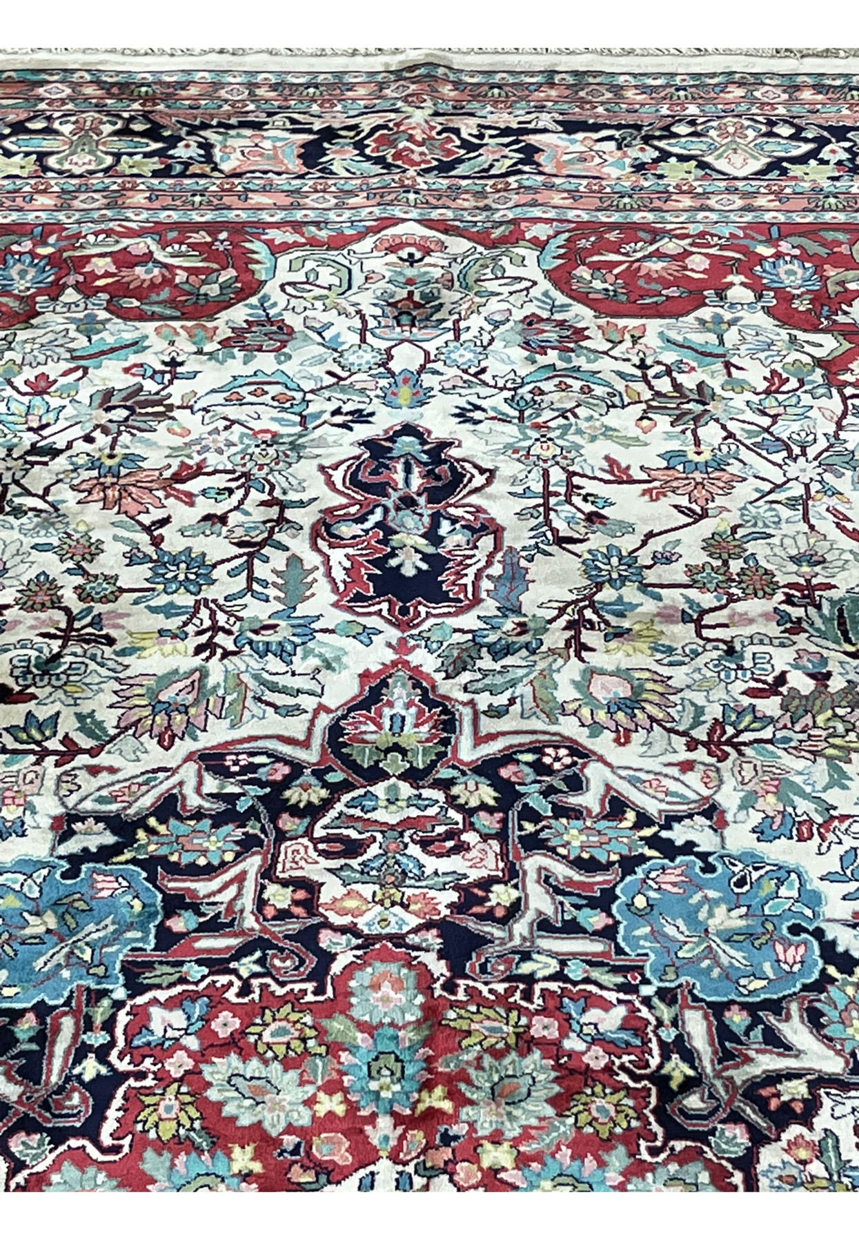 Close-up of floral vines and silk pile texture in ivory field