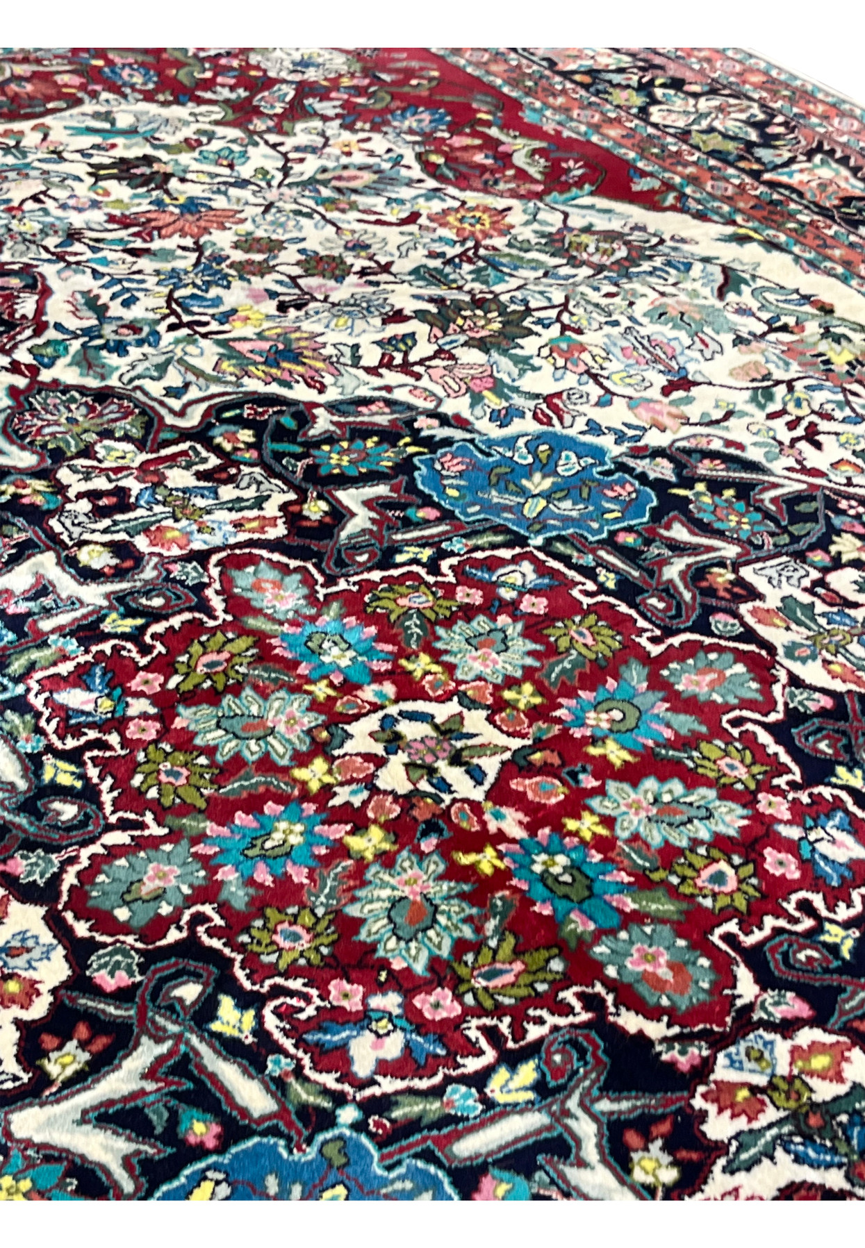 Medallion close-up of 6x9 oriental silk rug showing layered floral medallion in burgundy, turquoise, ivory, and navy accents