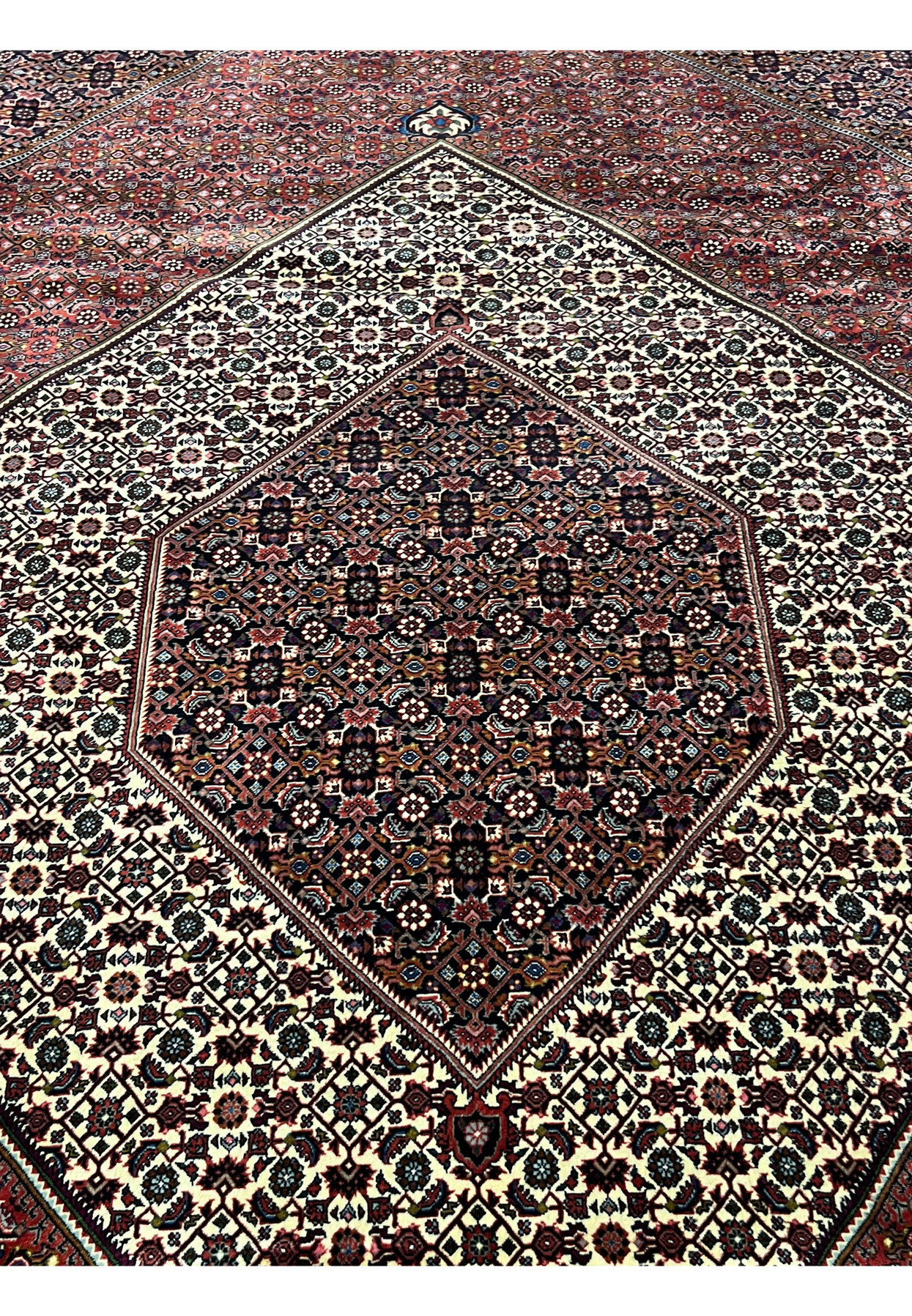 Close view of the diamond medallion with ivory ground and fine geometric detailing in a Persian Bijar rug