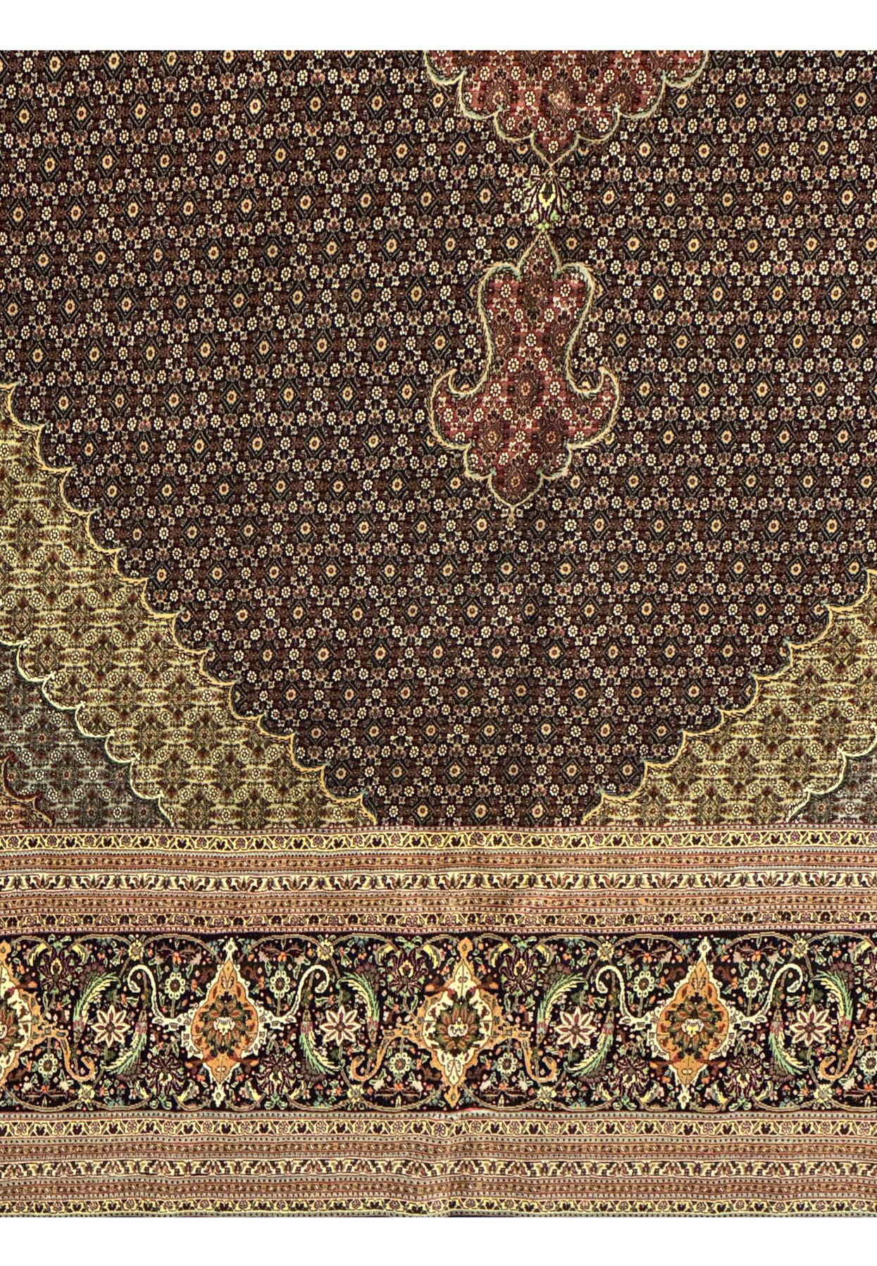 Lower section of Persian Tabriz Mahi rug showing dense repeating herati pattern with layered color transitions and tight knot structure