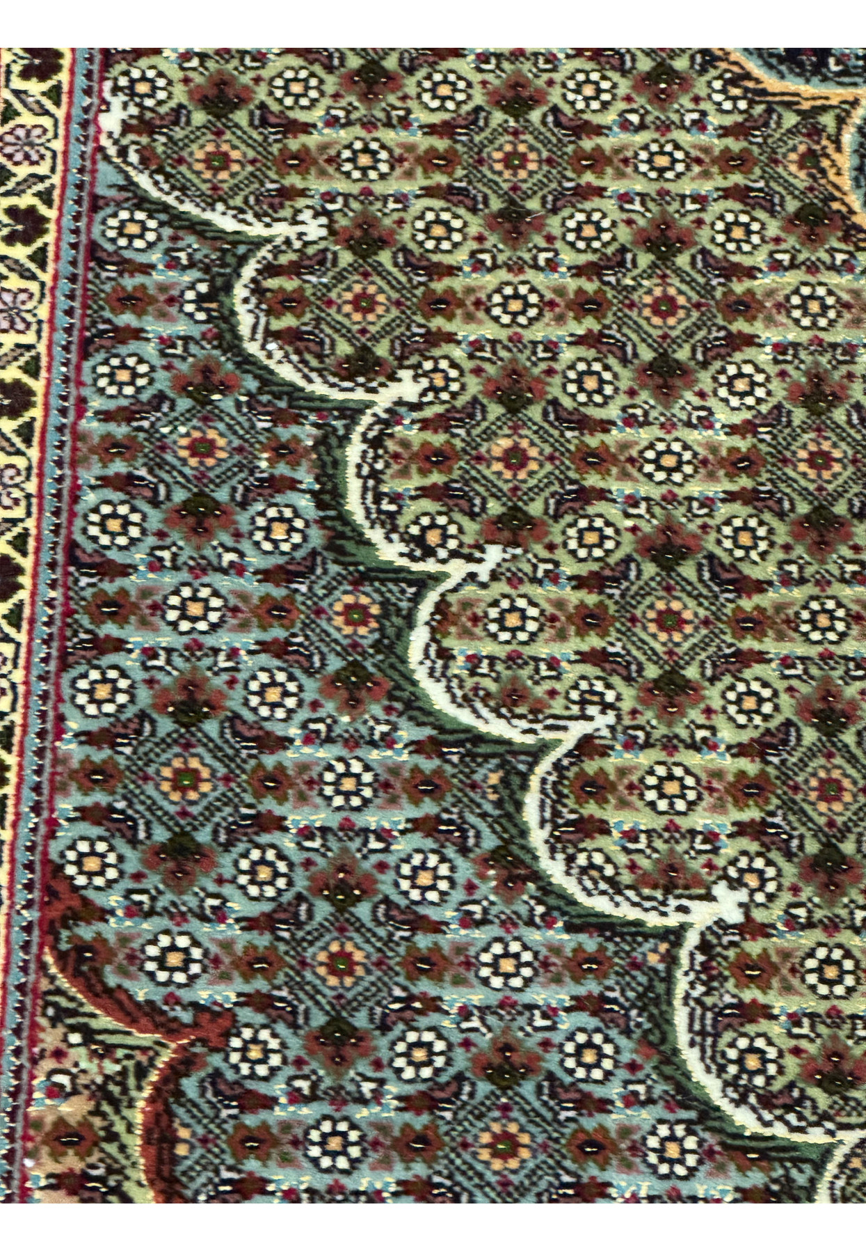 Close up of 11.5 x 16.5 Persian Tabriz Mahi 50 Raj rug showing dense repeating fish pattern with floral rosettes, fine knot structure, deep navy ground, and ivory detailing