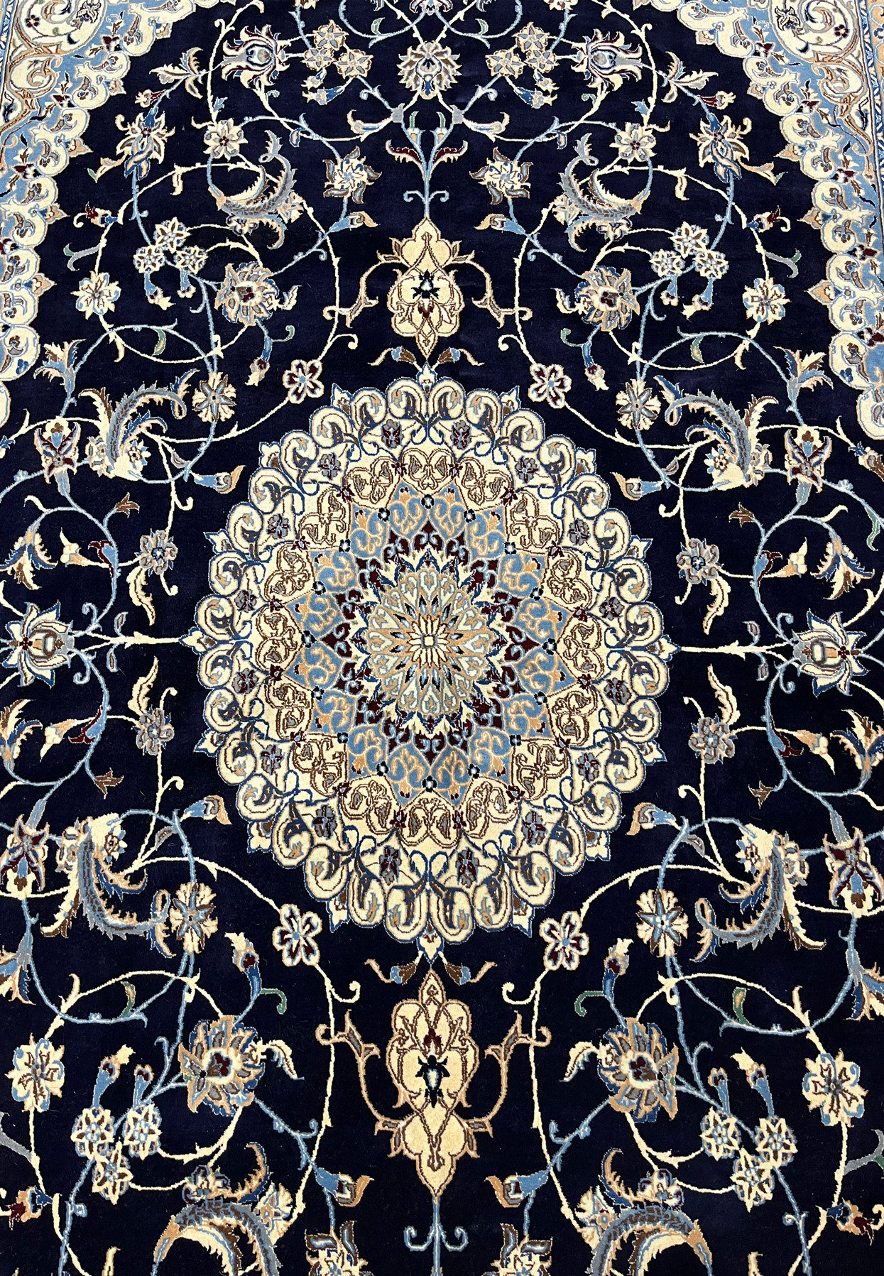 Midfield floral close-up of Persian Nain 6 LA silk rug revealing silk highlights, fine outlines, and intricate botanical motifs on navy field