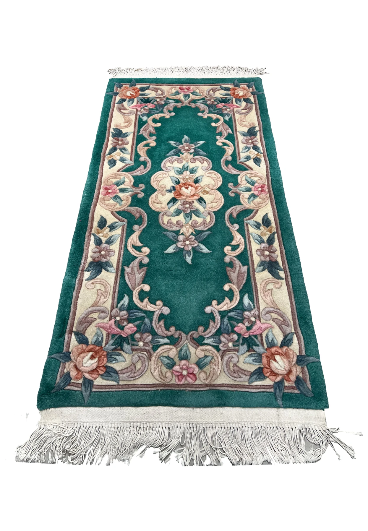 Laid flat Aubusson Art Deco rug showing emerald green background, sculpted floral scrolls, ivory framing, and balanced decorative layout