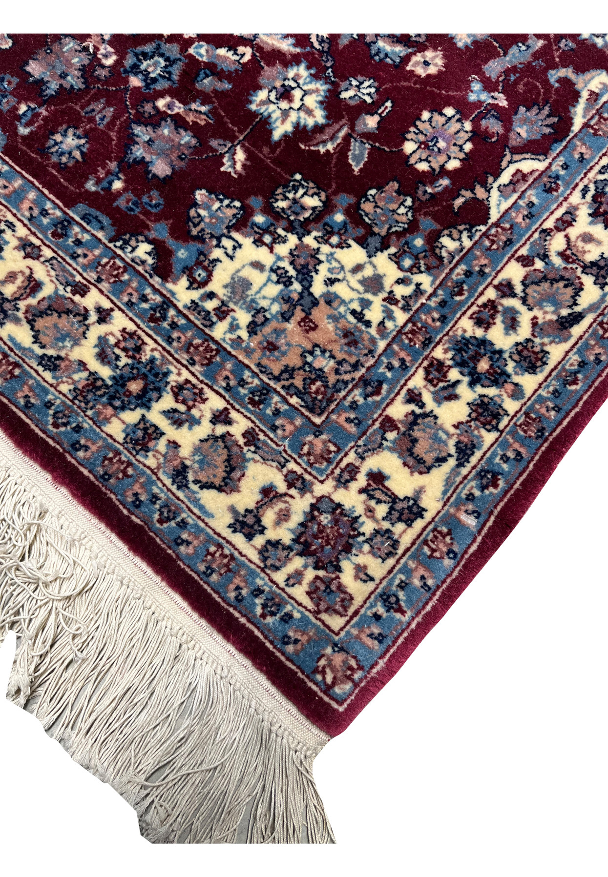 Edge view of a Persian Tabriz rug showing even finishing, crisp borders, tight weave structure, and consistent color definition along the rug perimeter