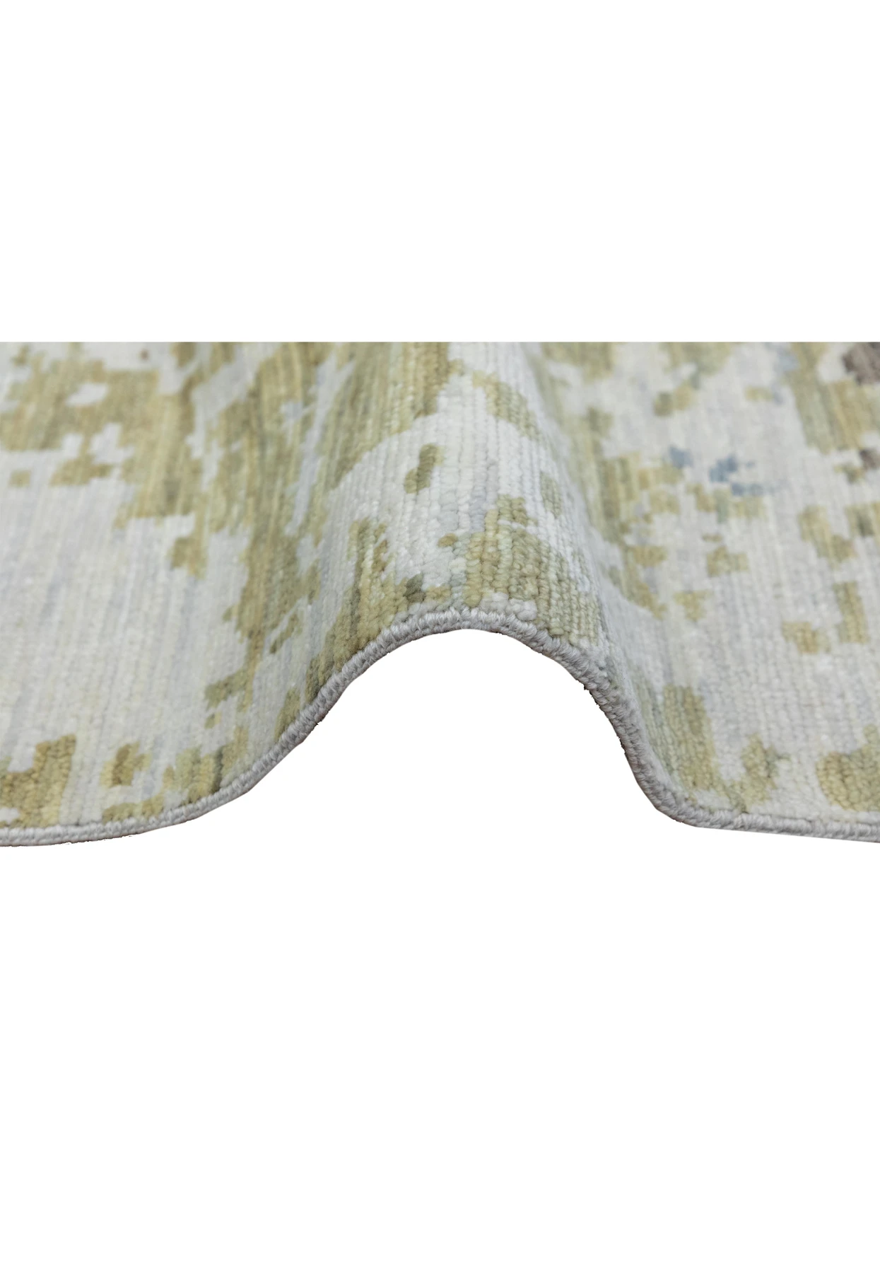 Side profile of a handmade Nepali wool rug displaying medium pile height, clean edge finish, and refined abstract color blending in blue and ivory tones.