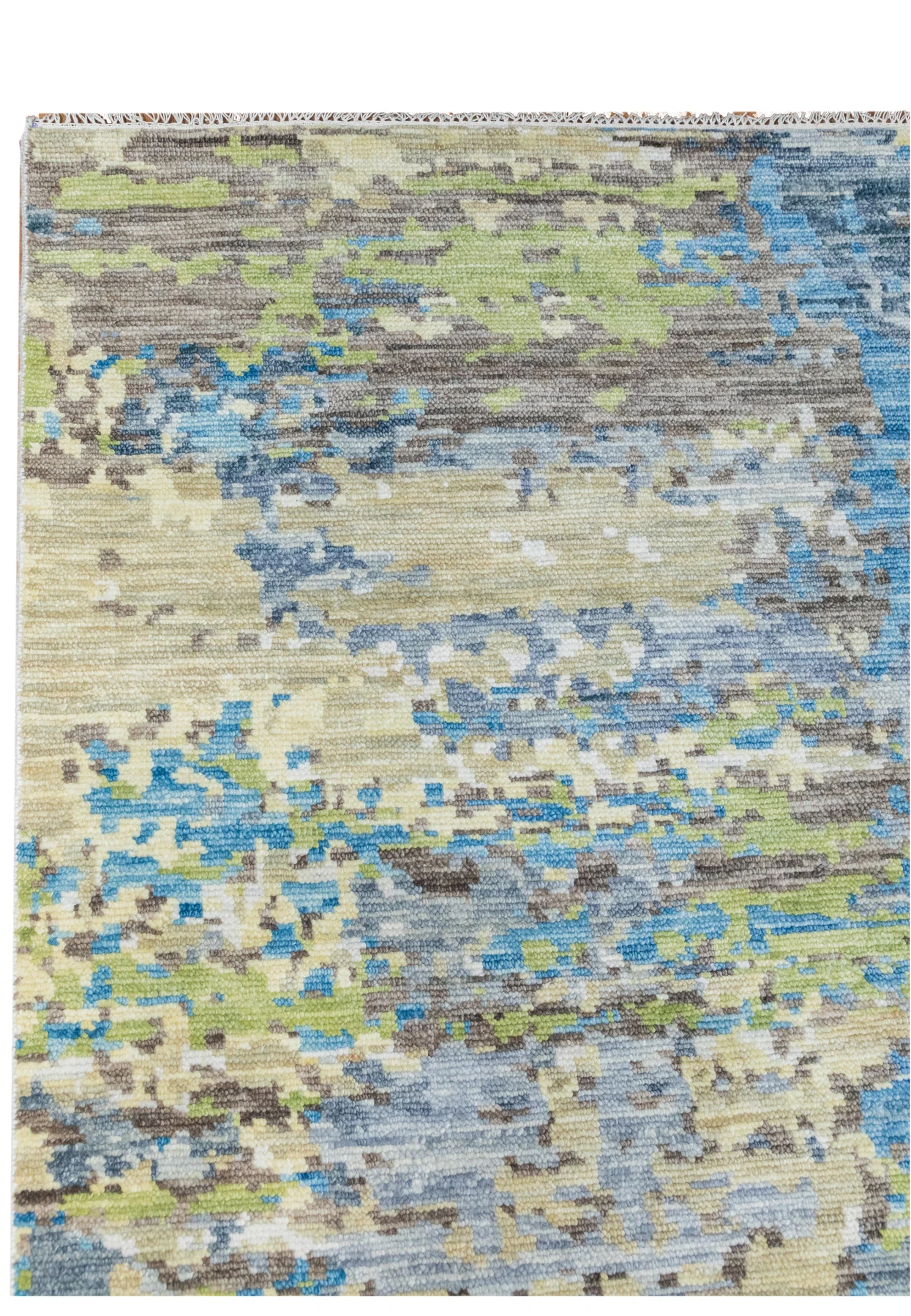 Close-up of the rug’s wool pile highlighting soft blue, ivory, gray, and muted teal hues woven into an abstract modern texture with subtle depth.