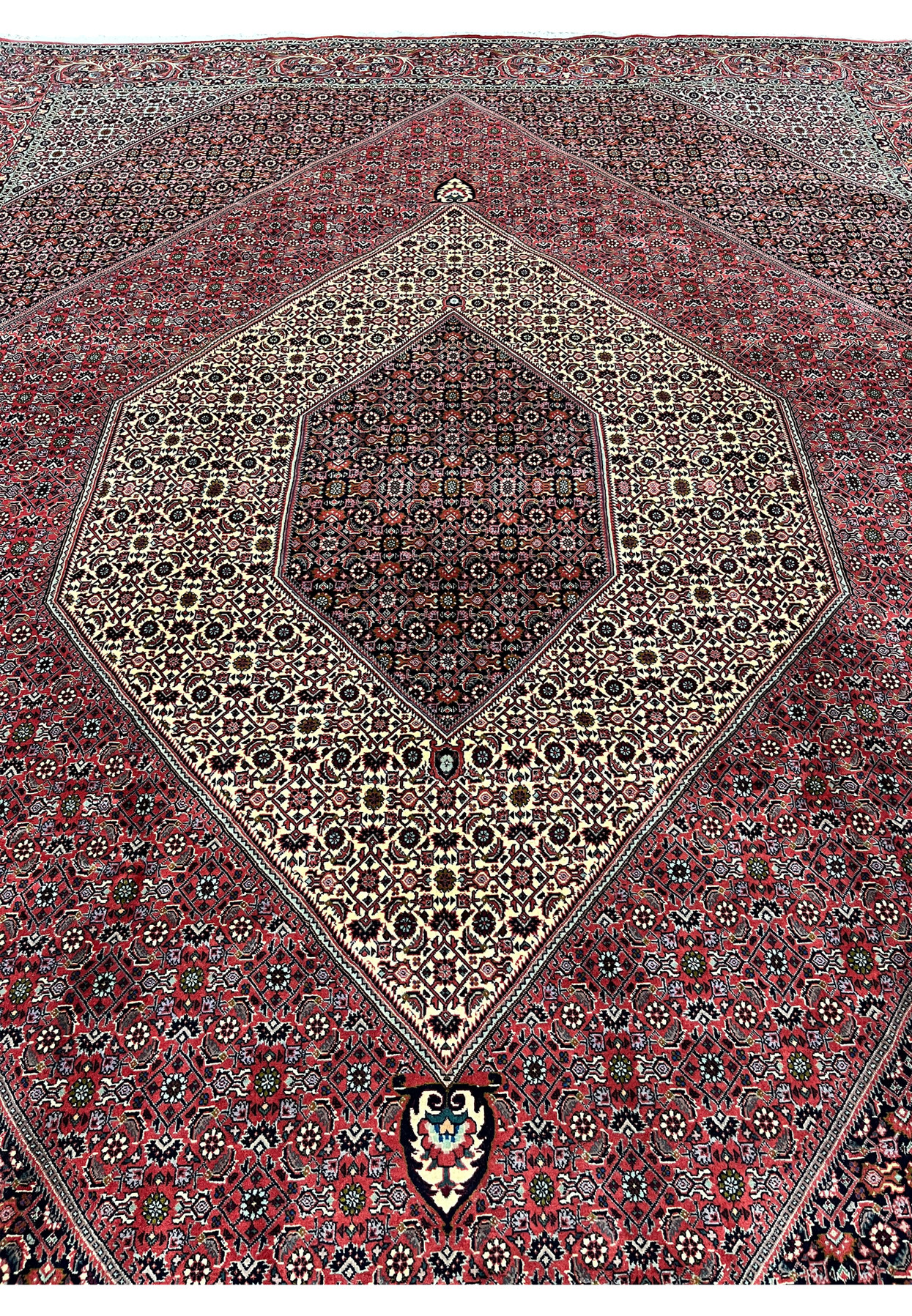 Midfield close-up of a Bijar iron rug revealing compact knot density, precise geometric layout, and layered color contrast within the wool field