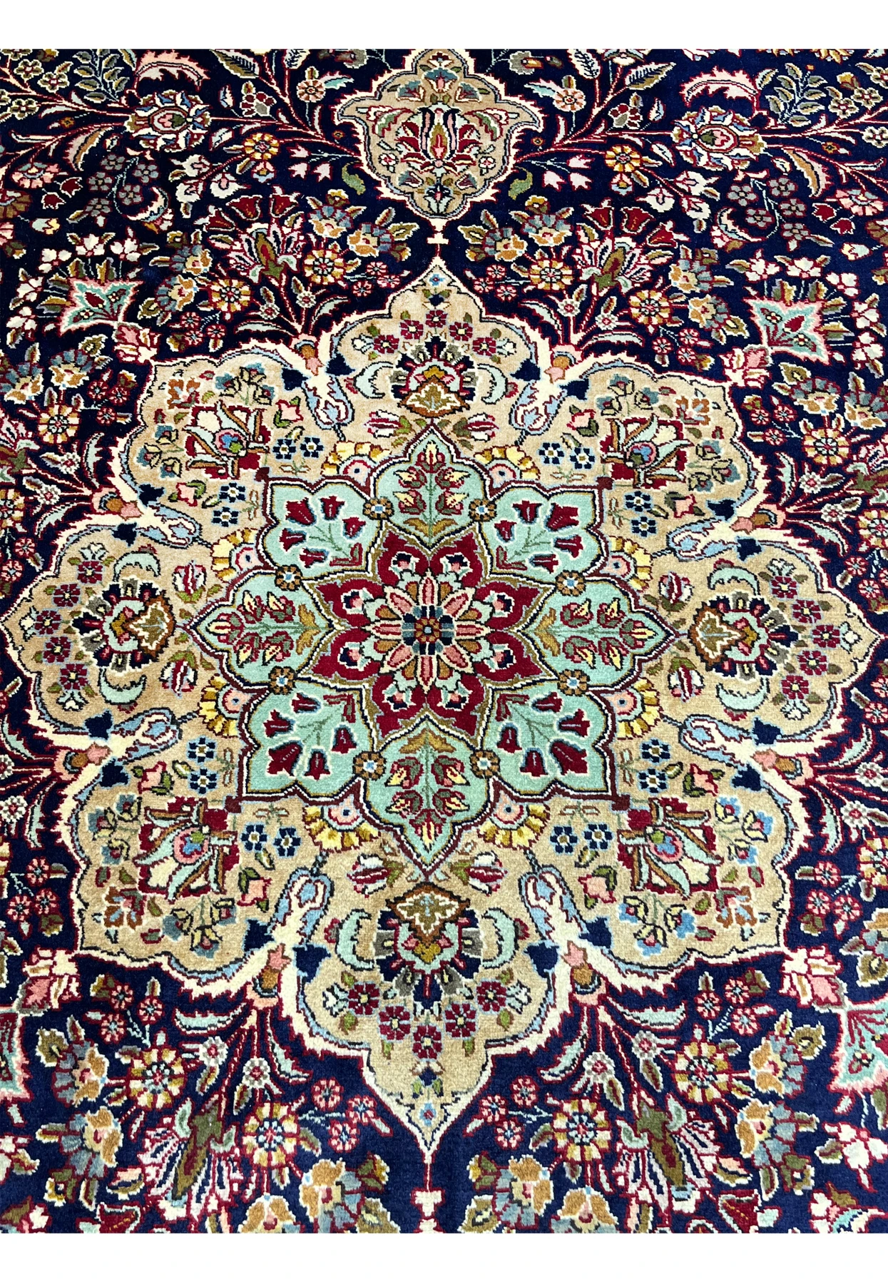 Zoomed detail of Persian Tabriz rug medallion highlighting intricate floral motifs, tight knotting, and refined color transitions