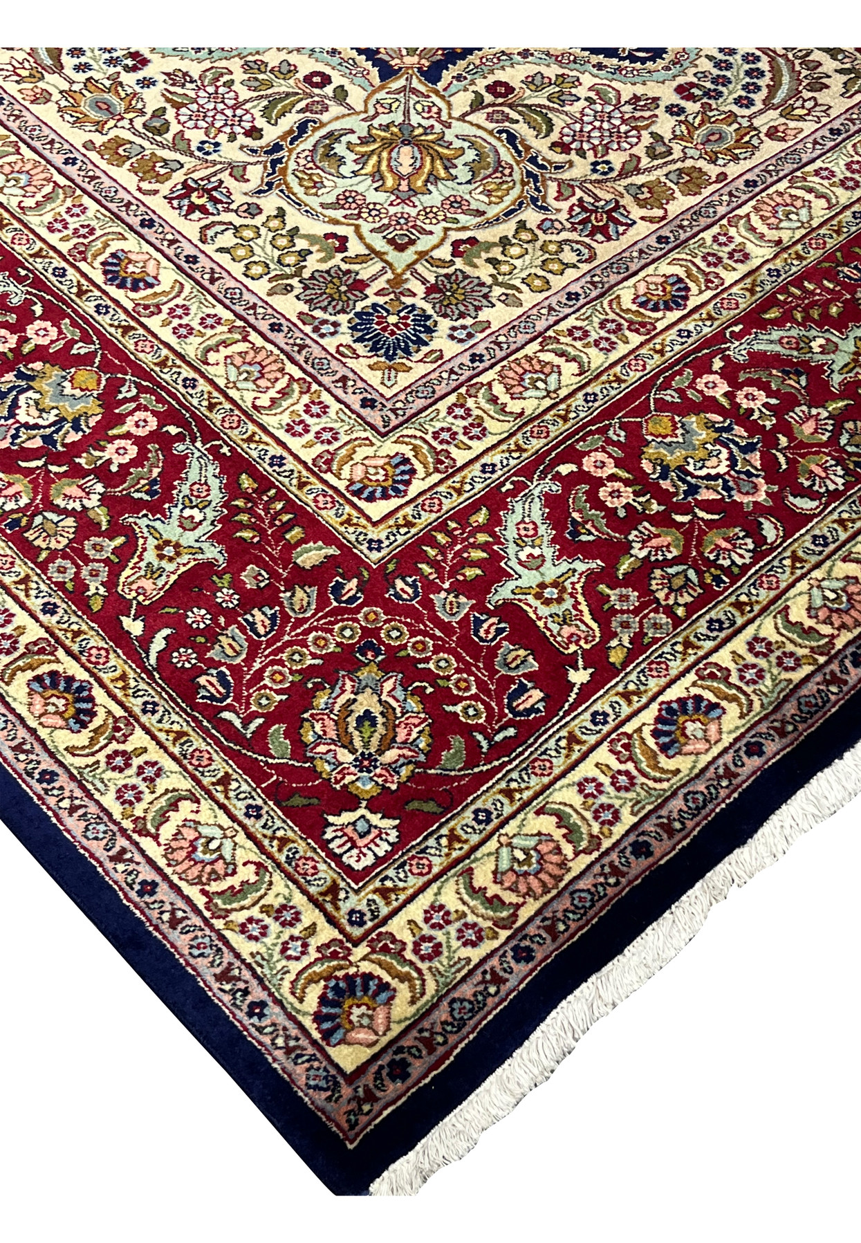 Side edge detail of an 11'2 x 14'4 Persian Tabriz rug showing precise knotting, navy field, ivory border, and clean wool finish