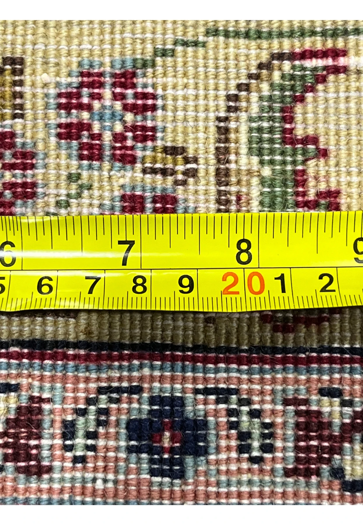 Zoomed backside detail of an 11'2 x 14'4 Persian Tabriz rug with ruler measuring knot density, showing fine weave and detailed craftsmanship