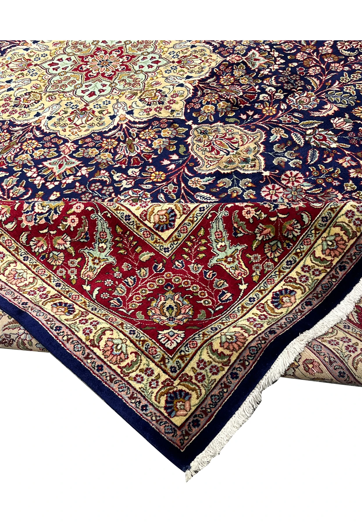 Folded edge view of an 11'2 x 14'4 Persian Tabriz rug showing deep navy field, ivory border details, tight pile, and refined floral motifs