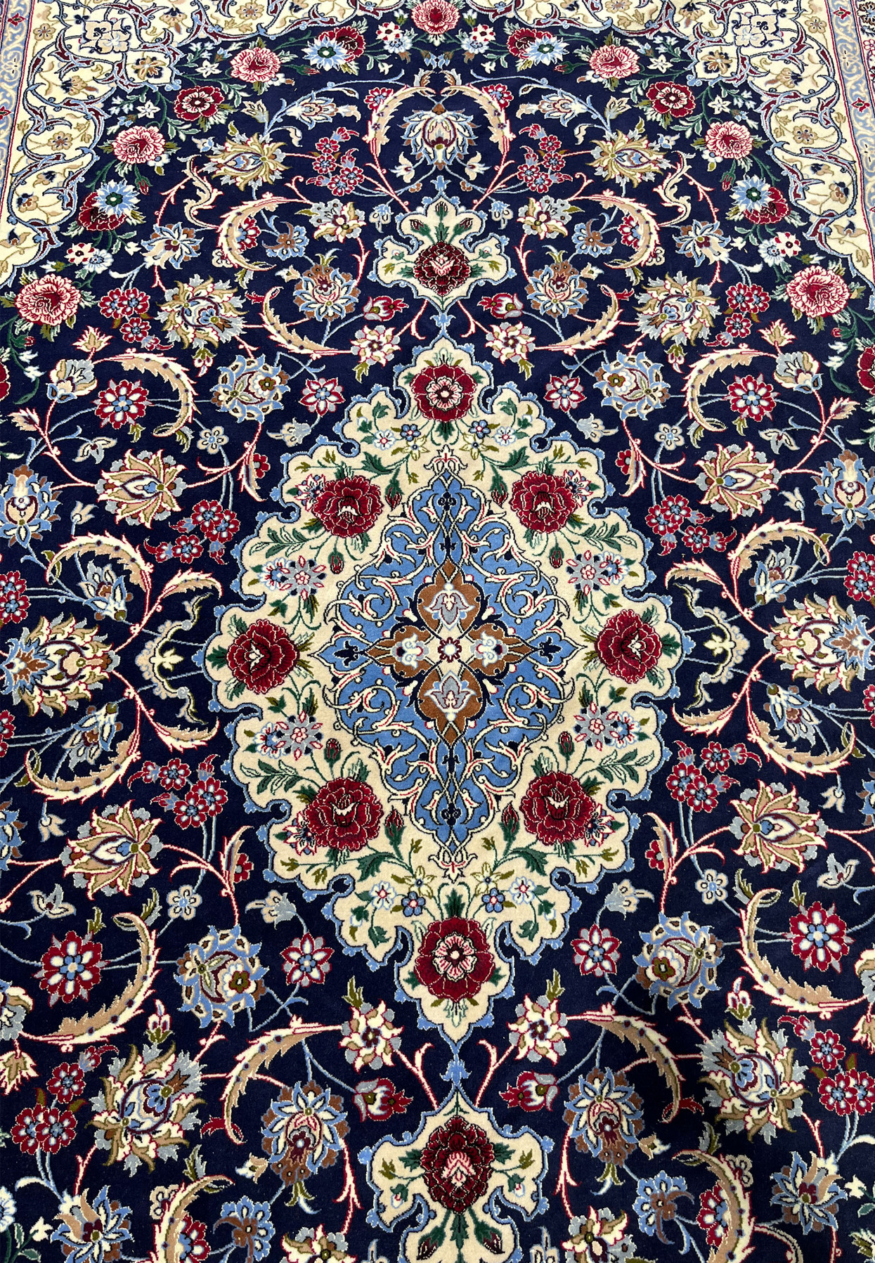 Full medallion view of a Persian Isfahan wool and silk rug with layered floral geometry, silk outlining, and crisp high knot density definition