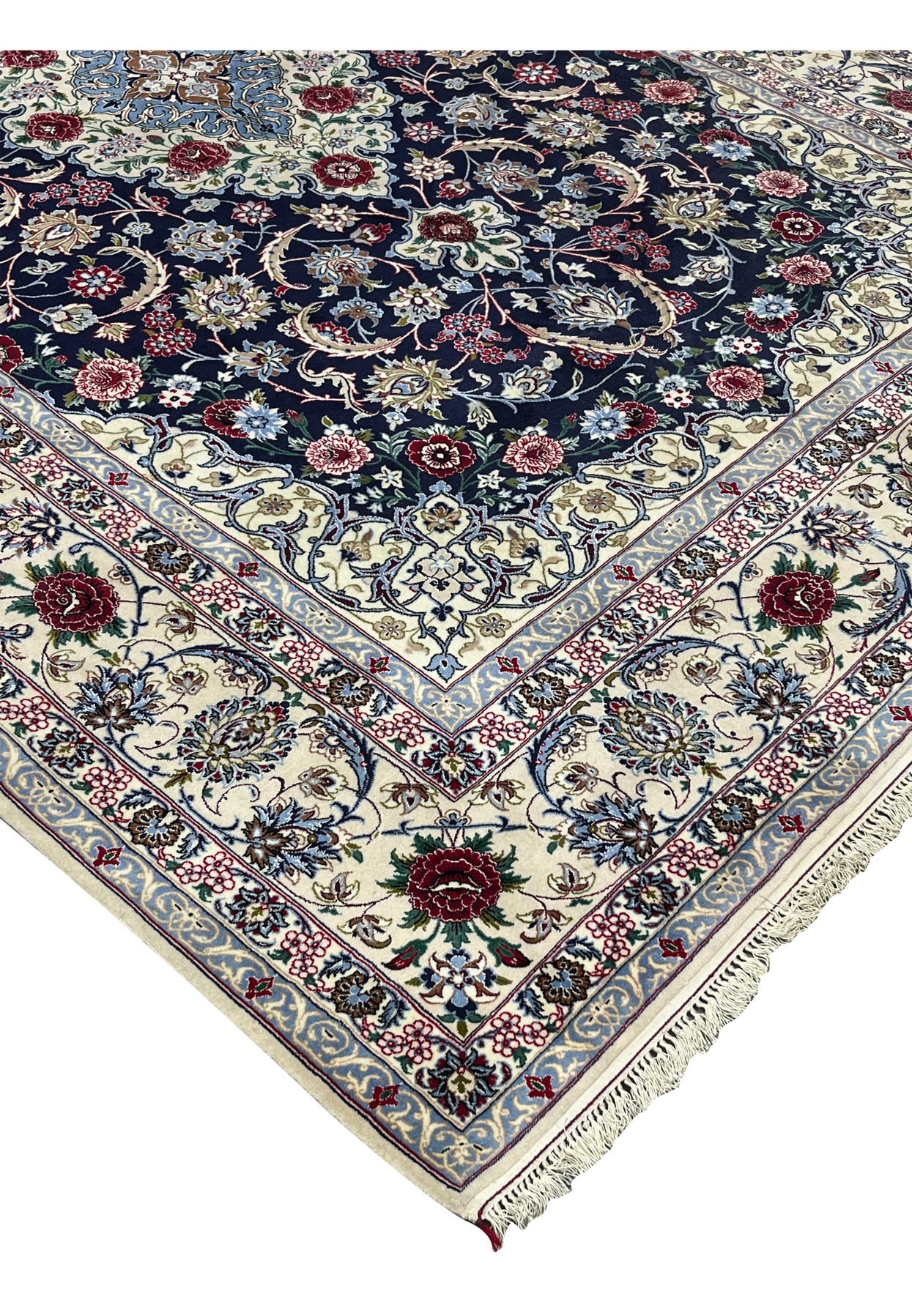 Side edge view of a Persian Isfahan rug showing clean selvedge, tight knot structure, and rich navy, ivory, and burgundy color palette