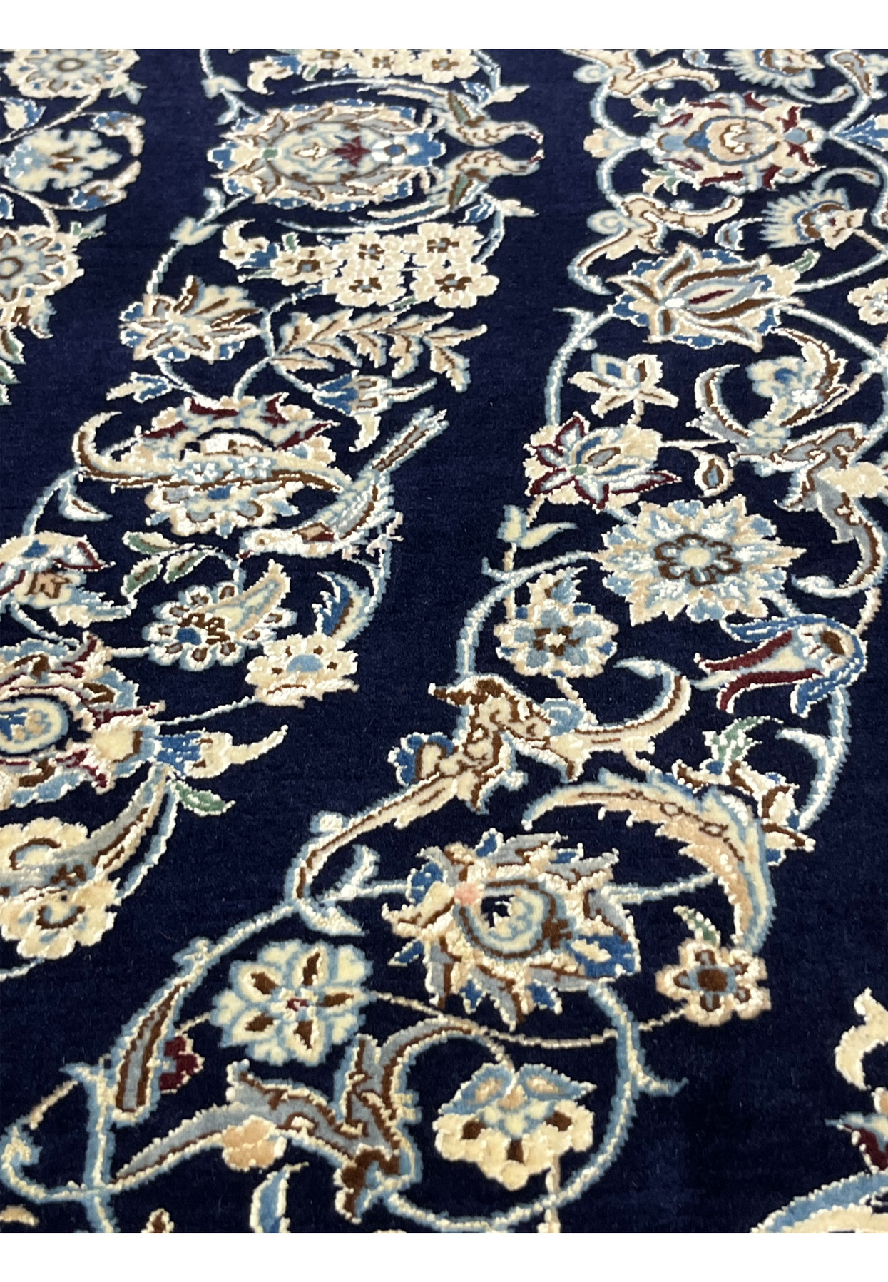Detailed design view of a Persian Nain 6 La rug showing intricate floral elements and precise silk detailing