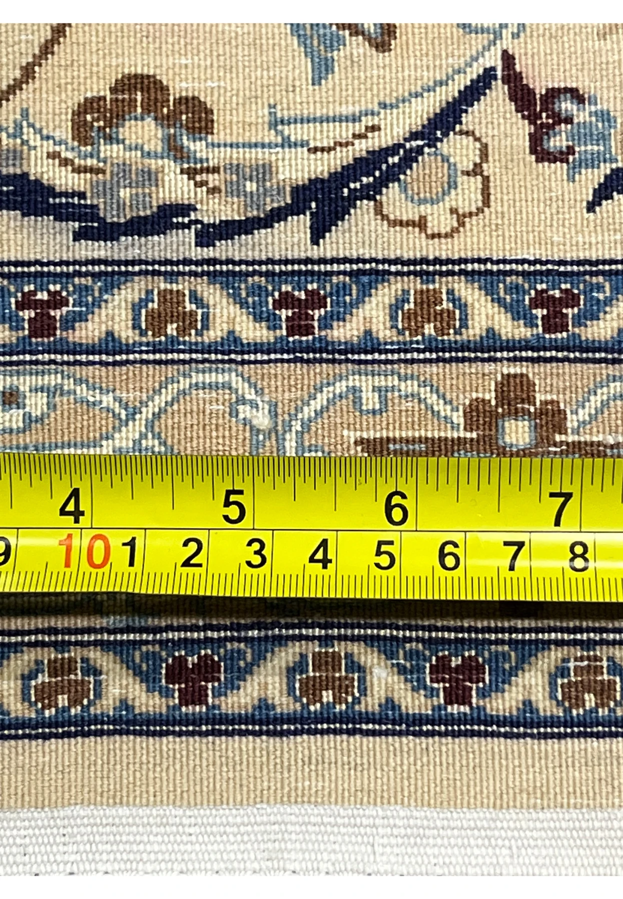 Knot close-up on the back of a Persian Nain 6 La rug showing precise hand-knotting and fine silk foundation