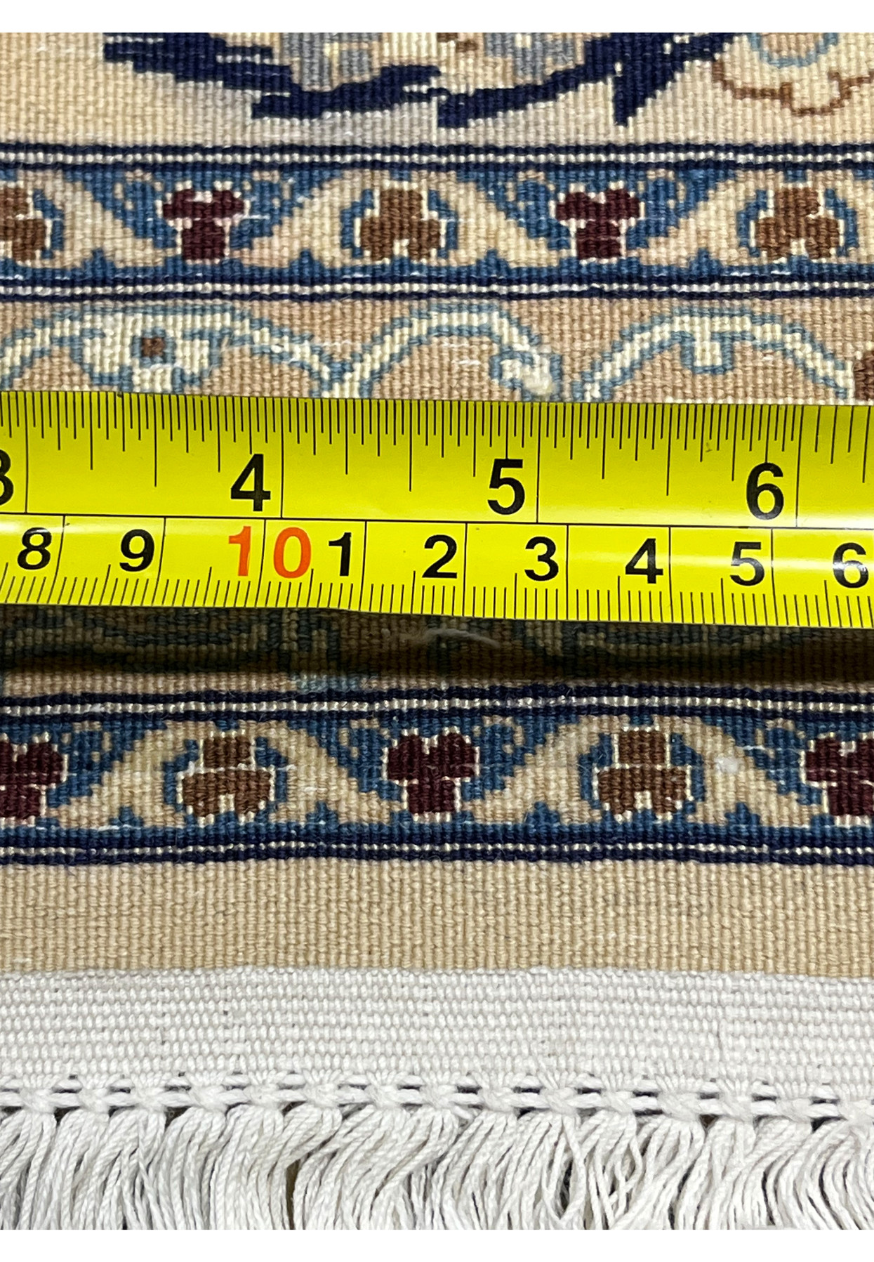 Measured backside view of a Persian Nain 6 La rug displaying tight knot count and fine weaving precision
