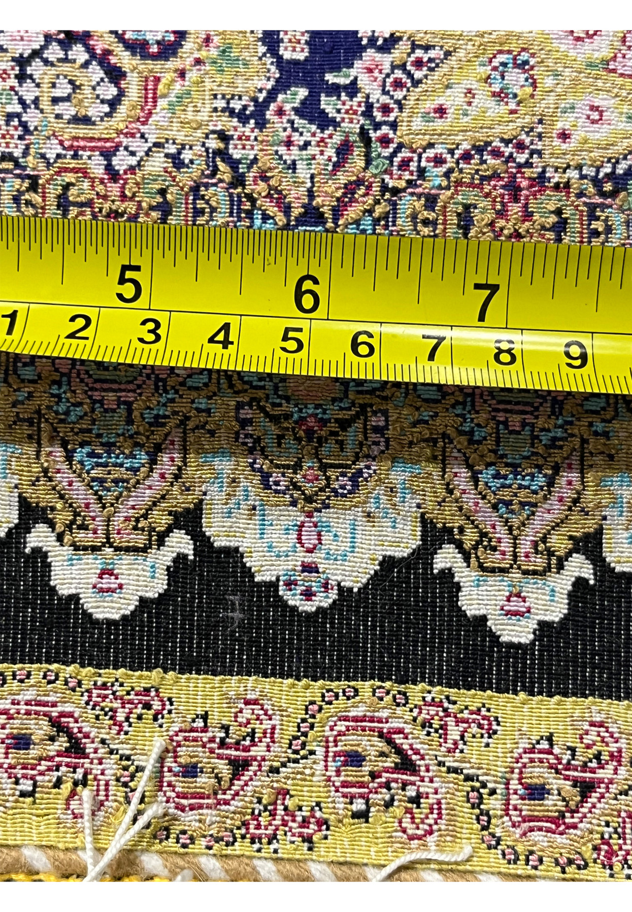 Measured backside view of a signed Persian Qum pure silk rug showing fine weave density and knot precision