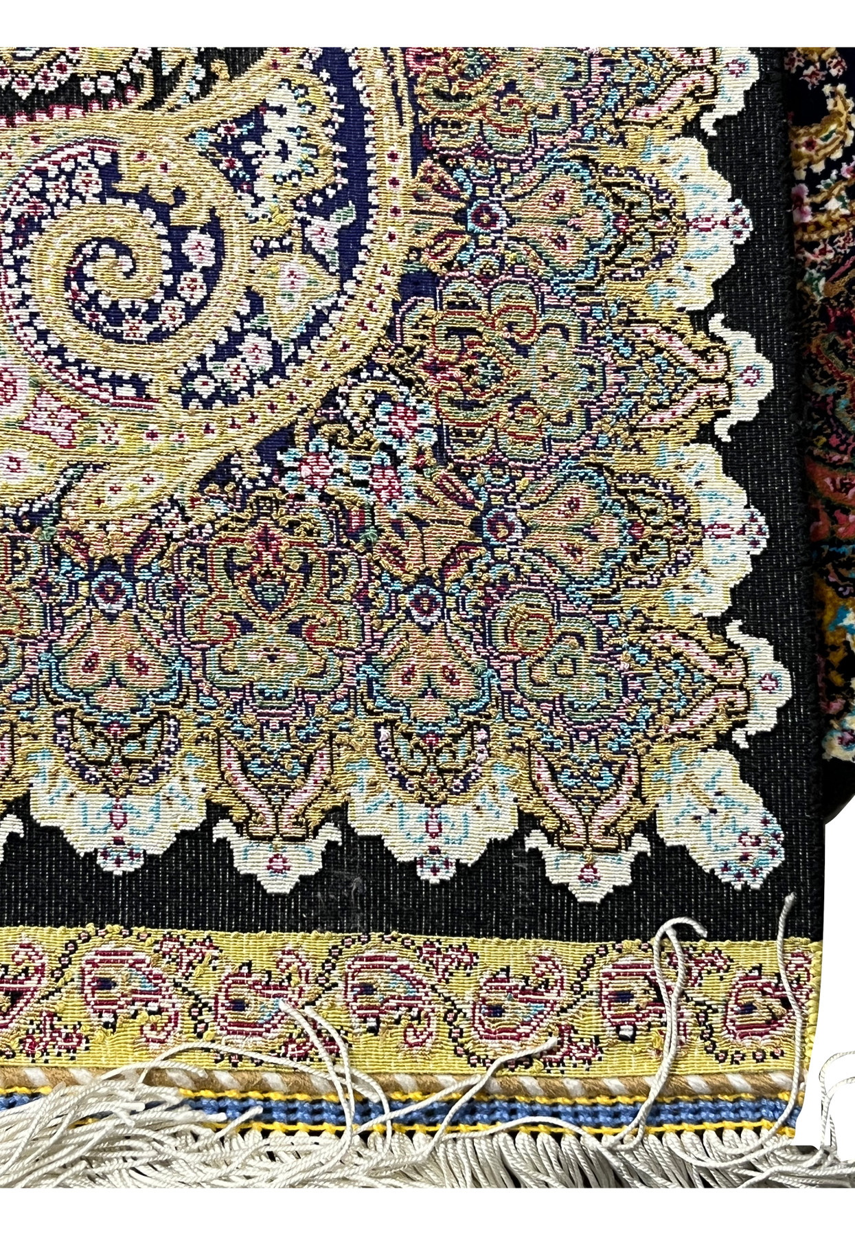 Backside of a signed Persian Qum silk rug revealing tight knot density and precise hand-knotting